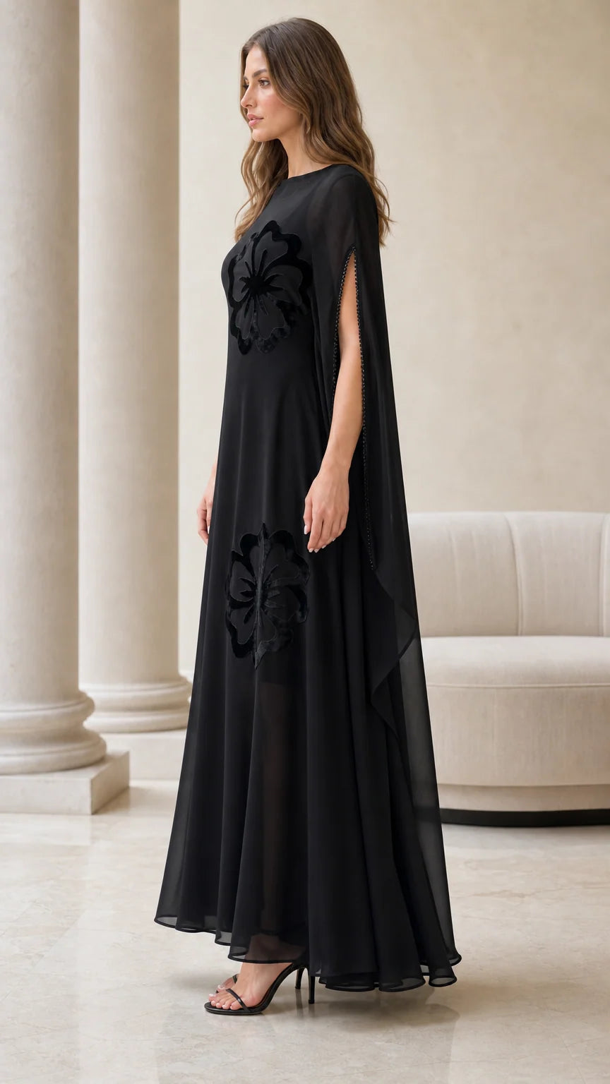 Side angle of black sheer chiffon cape dress showing split sleeves