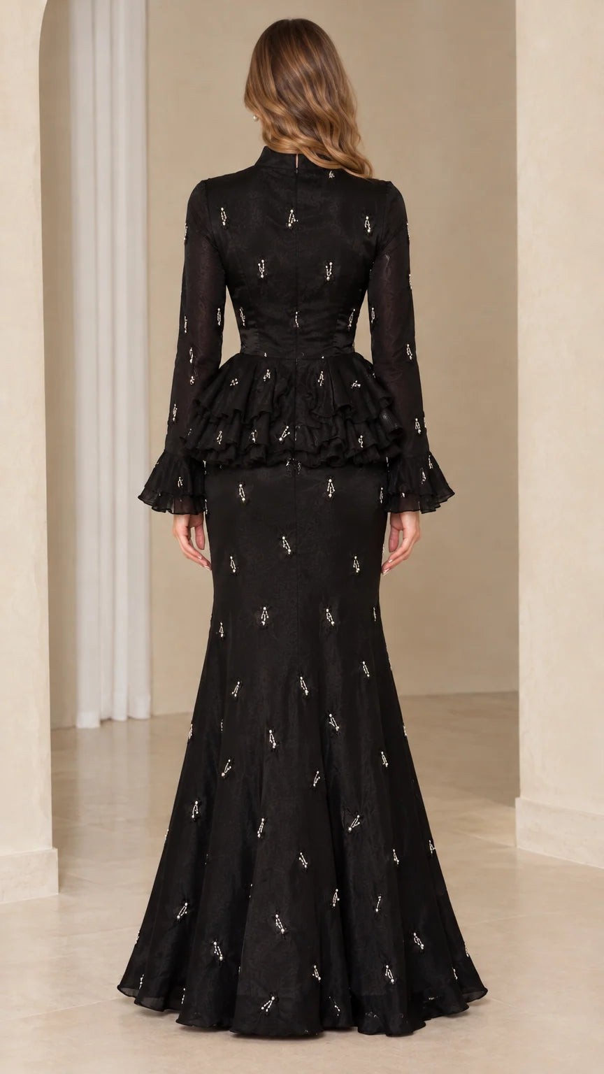 Back full-length view of black mermaid peplum formal gown