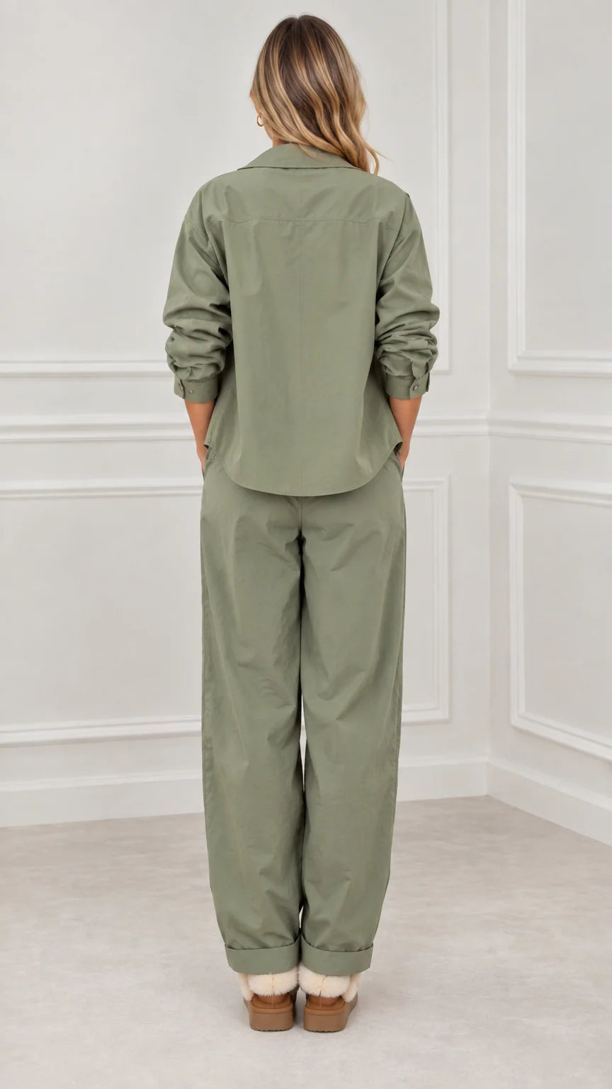 Back full view of woman wearing sage green relaxed utility tracksuit set