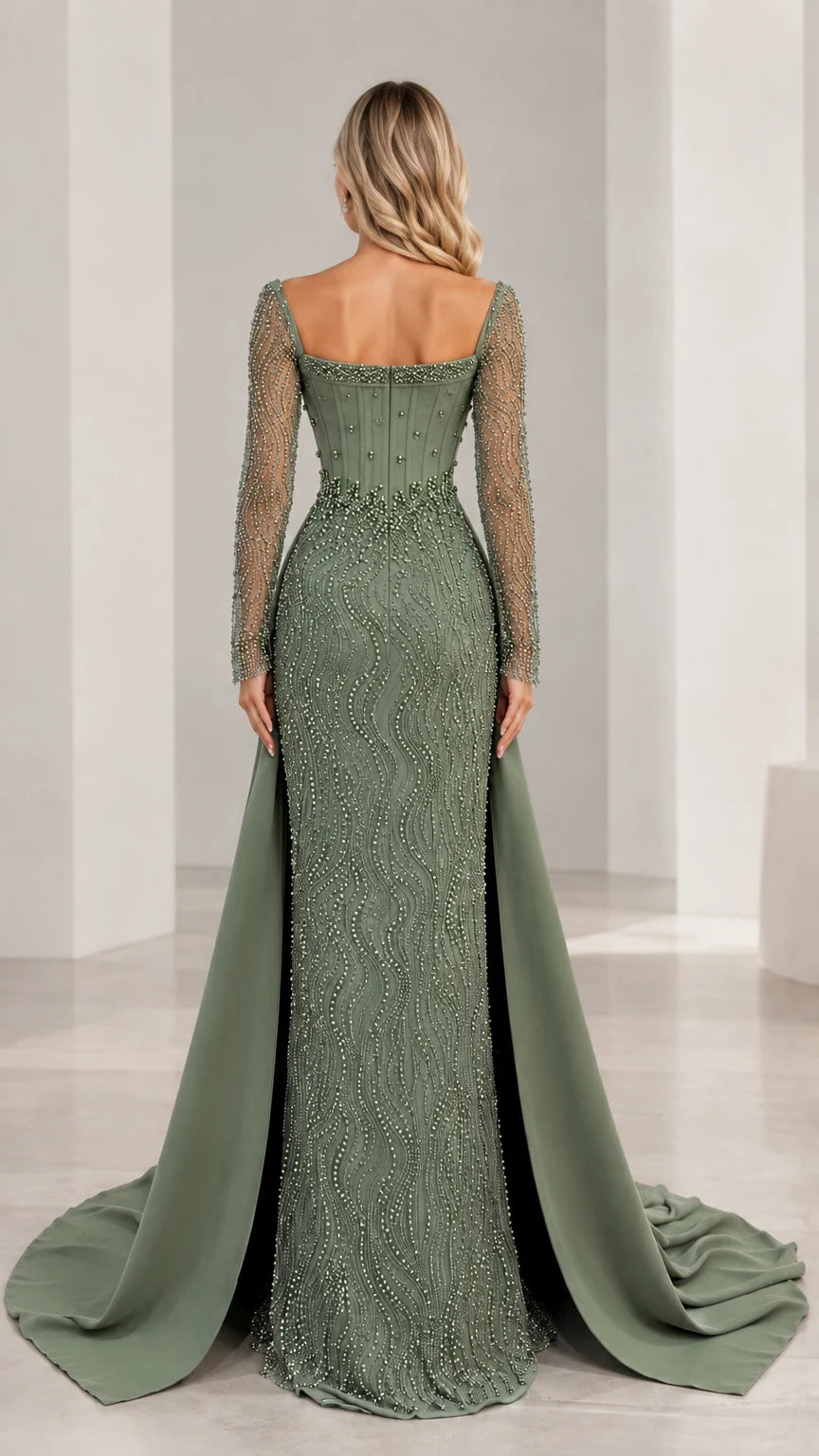 Back view of sage green formal gown featuring structured bodice and flowing overskirt