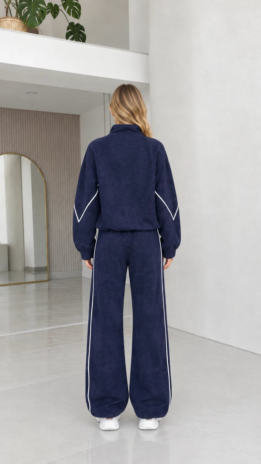 Back view of women's navy blue textured fleece tracksuit set