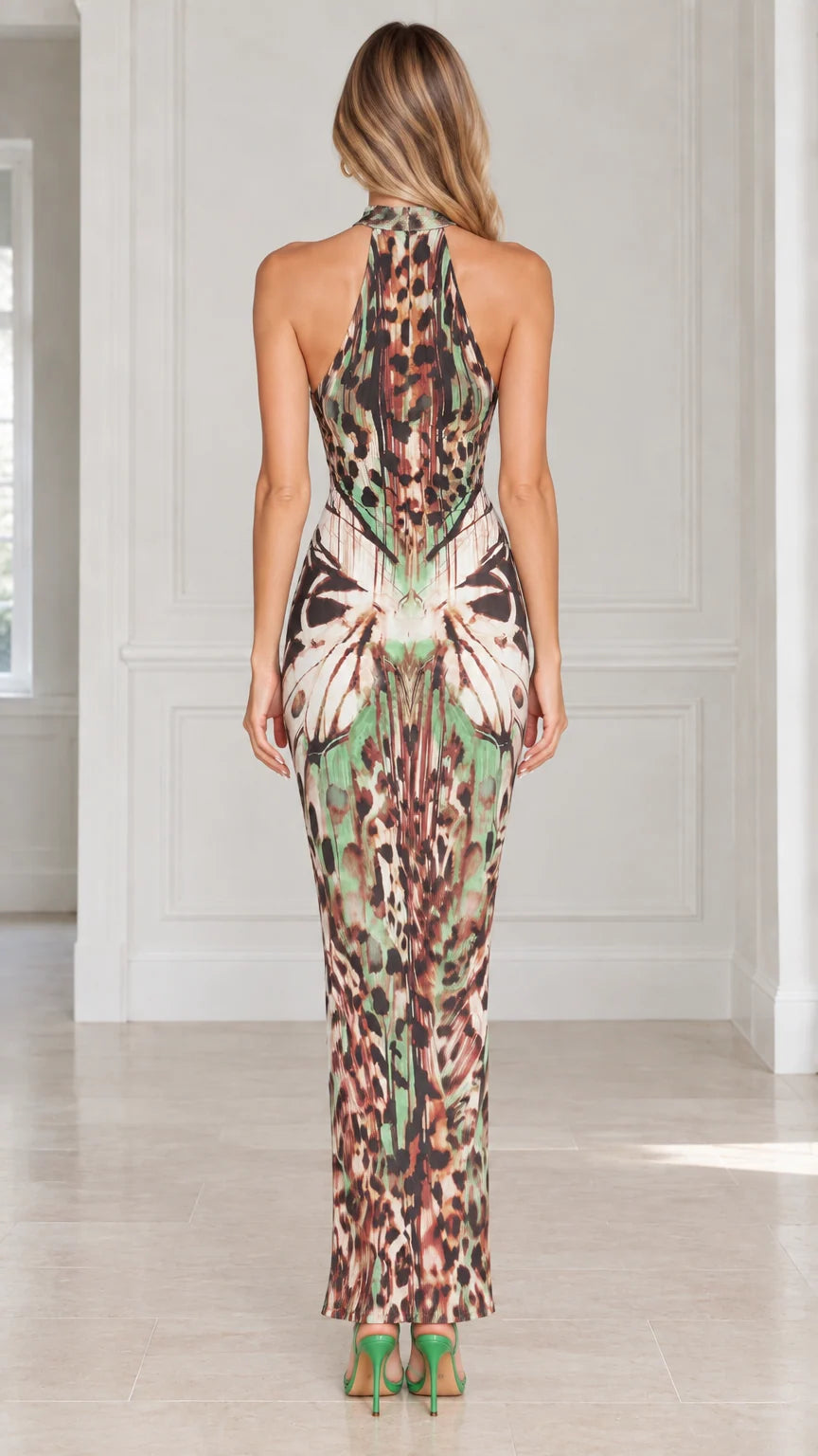 Back view of model showing open back and racerback halter neckline on maxi dress