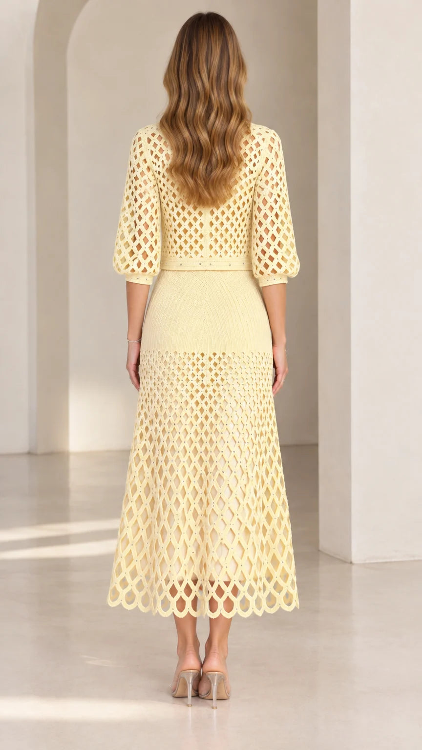 Back view of pale yellow crochet cardigan and midi skirt set