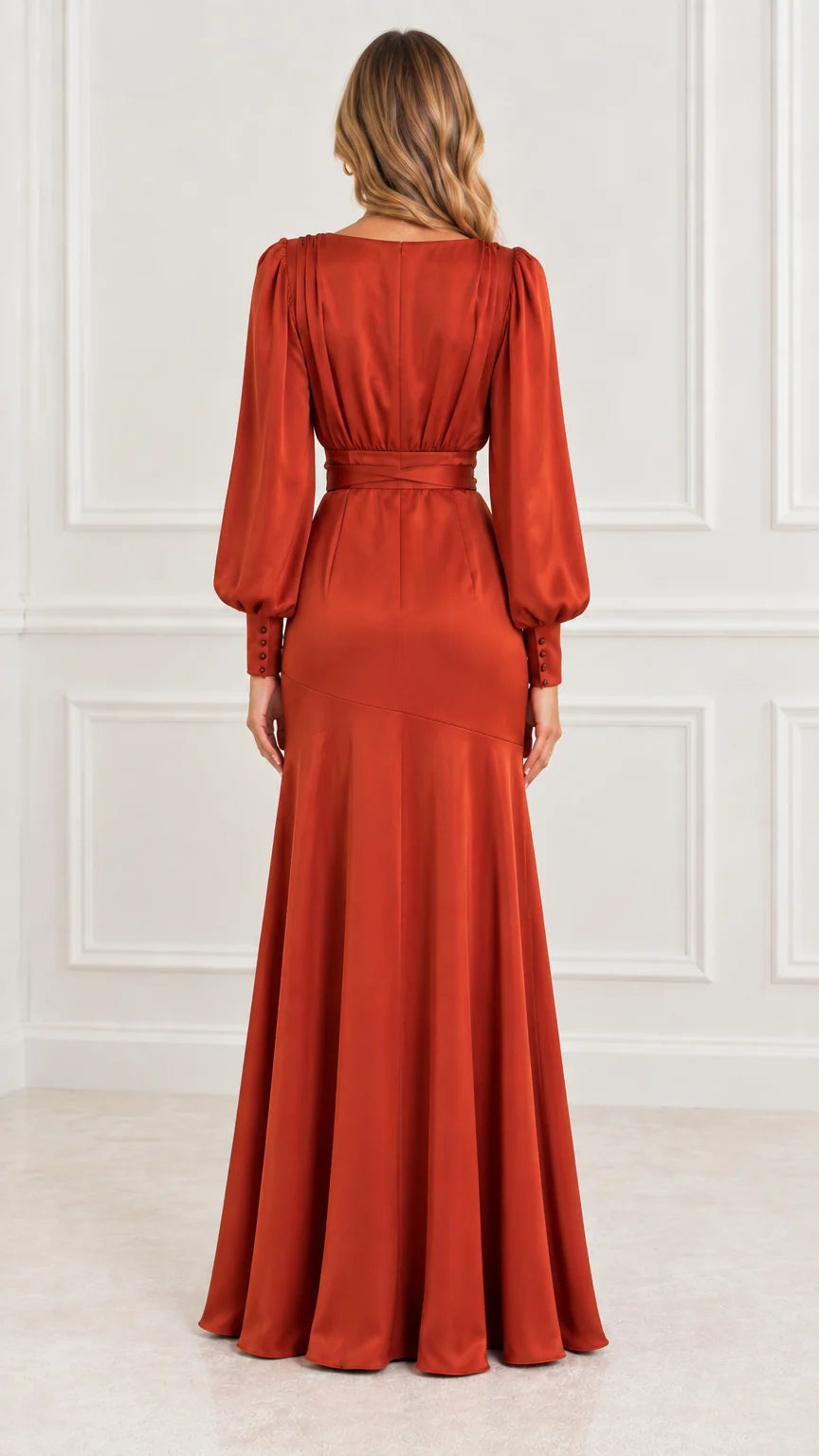 Back view of model in rust orange satin long sleeve maxi gown