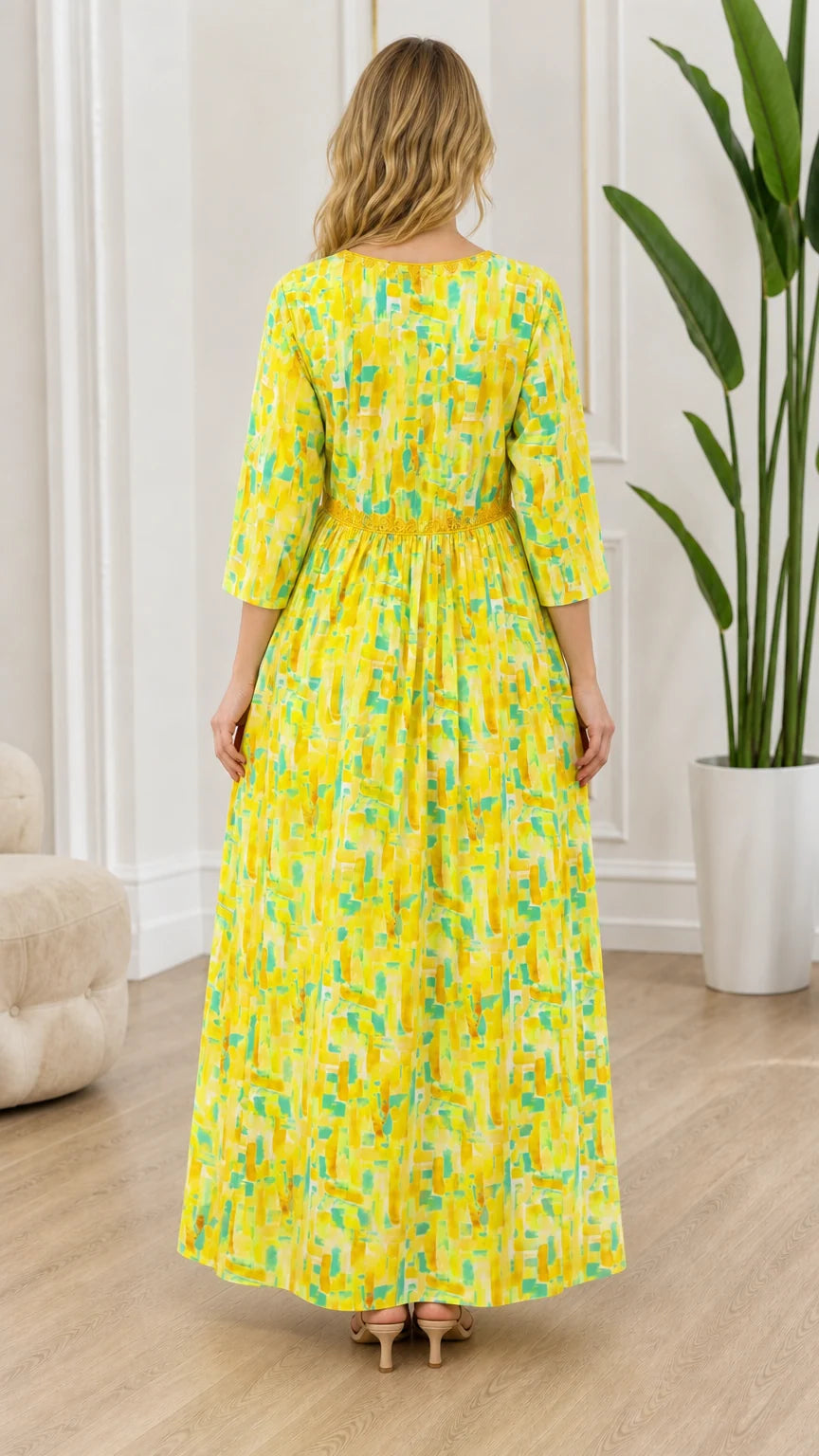 Back view of model wearing yellow patterned maxi dress with gathered empire waist