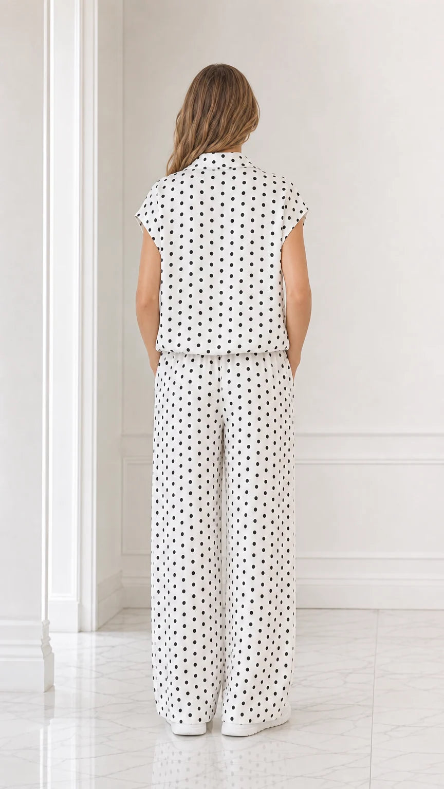 Back view of model showcasing the relaxed fit of the white polka dot 2-piece set