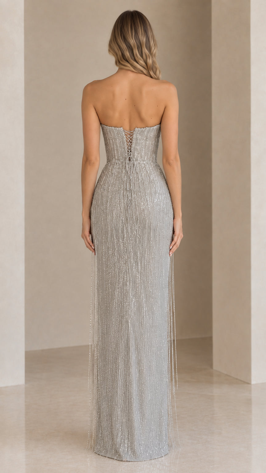 Back view of silver beaded gown highlighting the lace-up corset back detail