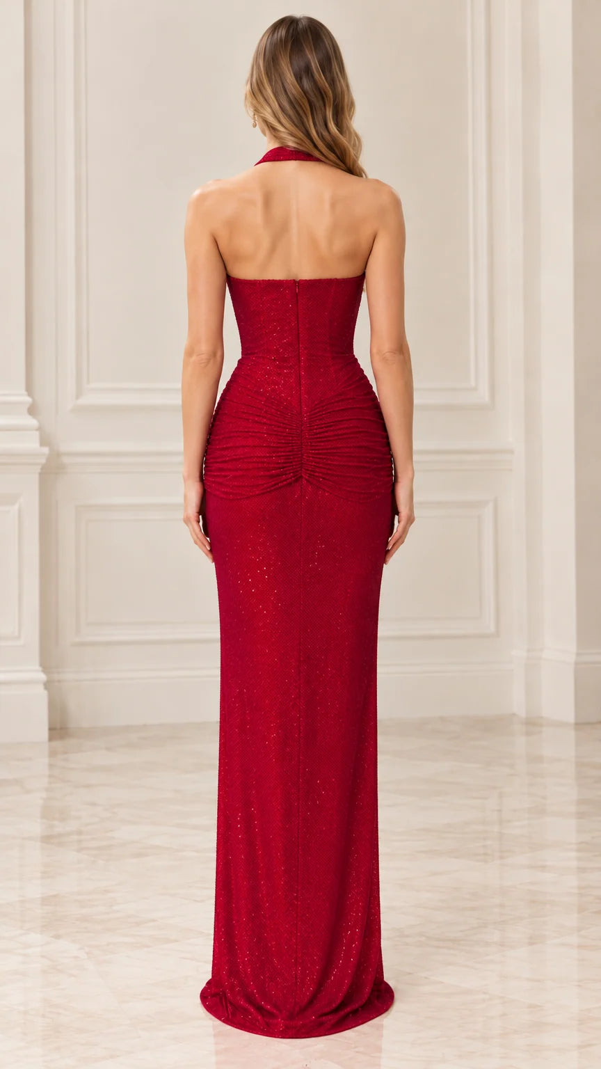 Back view of red halter evening dress highlighting open back design