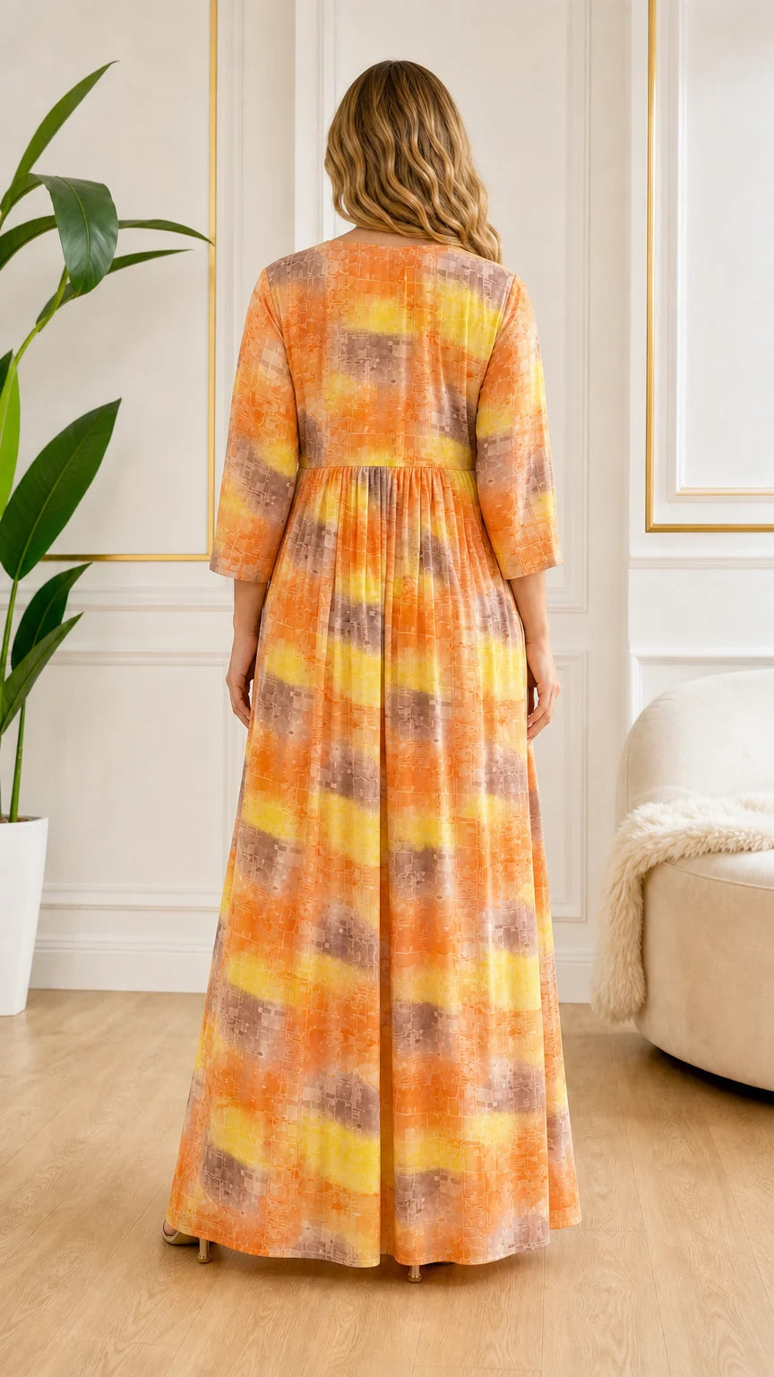 Back view of model showing full length drape of Orange abstract print maxi dress