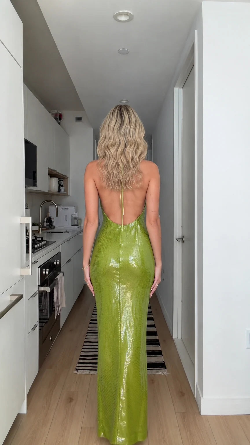 Back view of model showing open back design of lime green sequin maxi dress