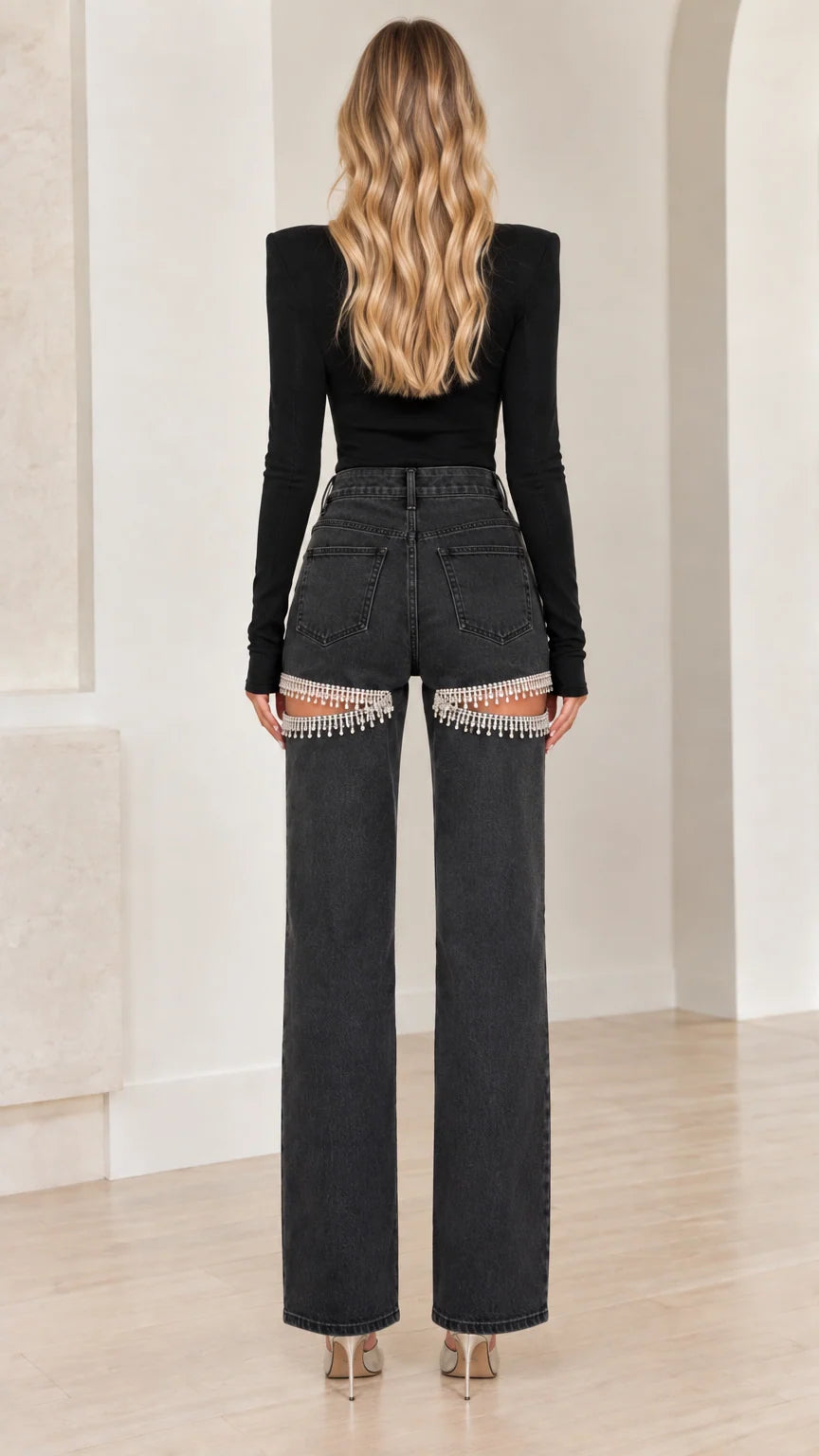 Back view of model in washed black wide leg rhinestone cutout jeans