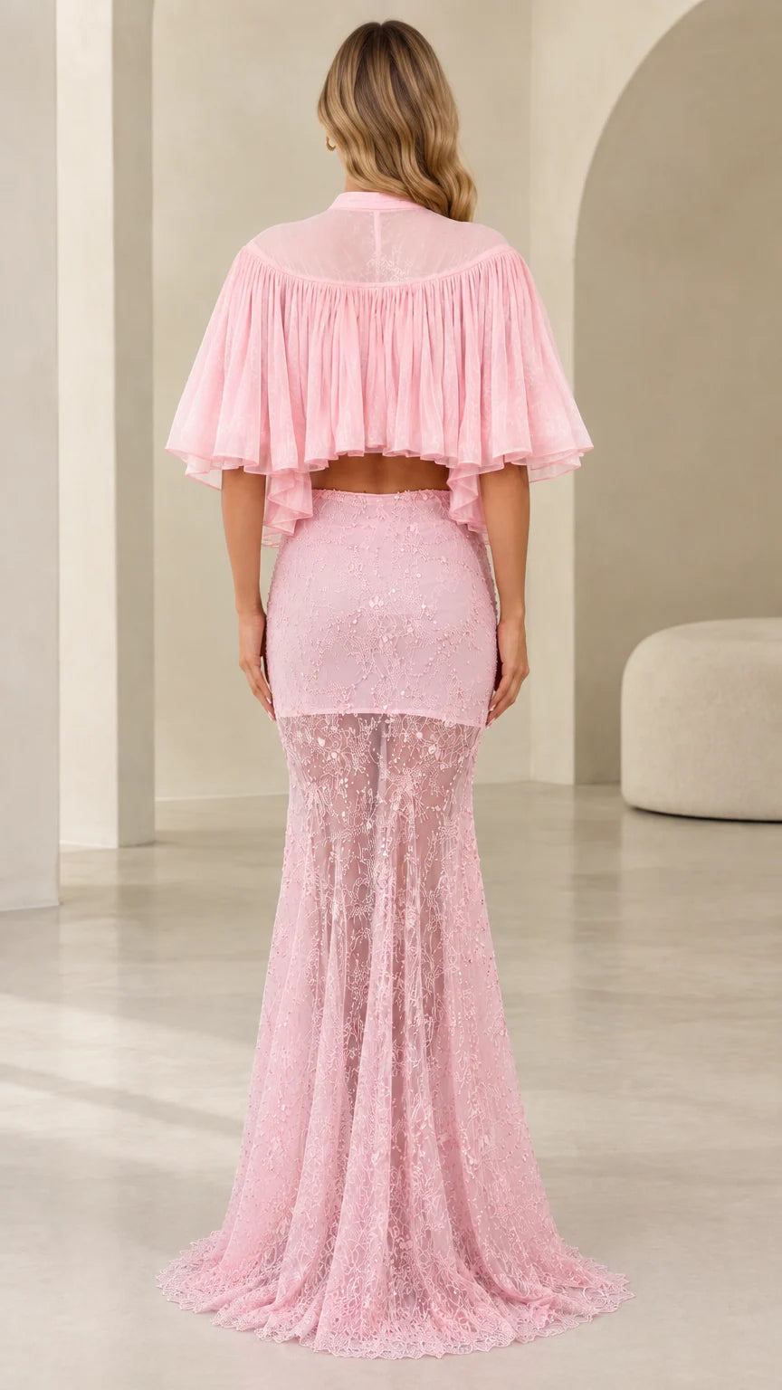 Back view of model wearing pink two-piece evening set with sheer pleated capelet