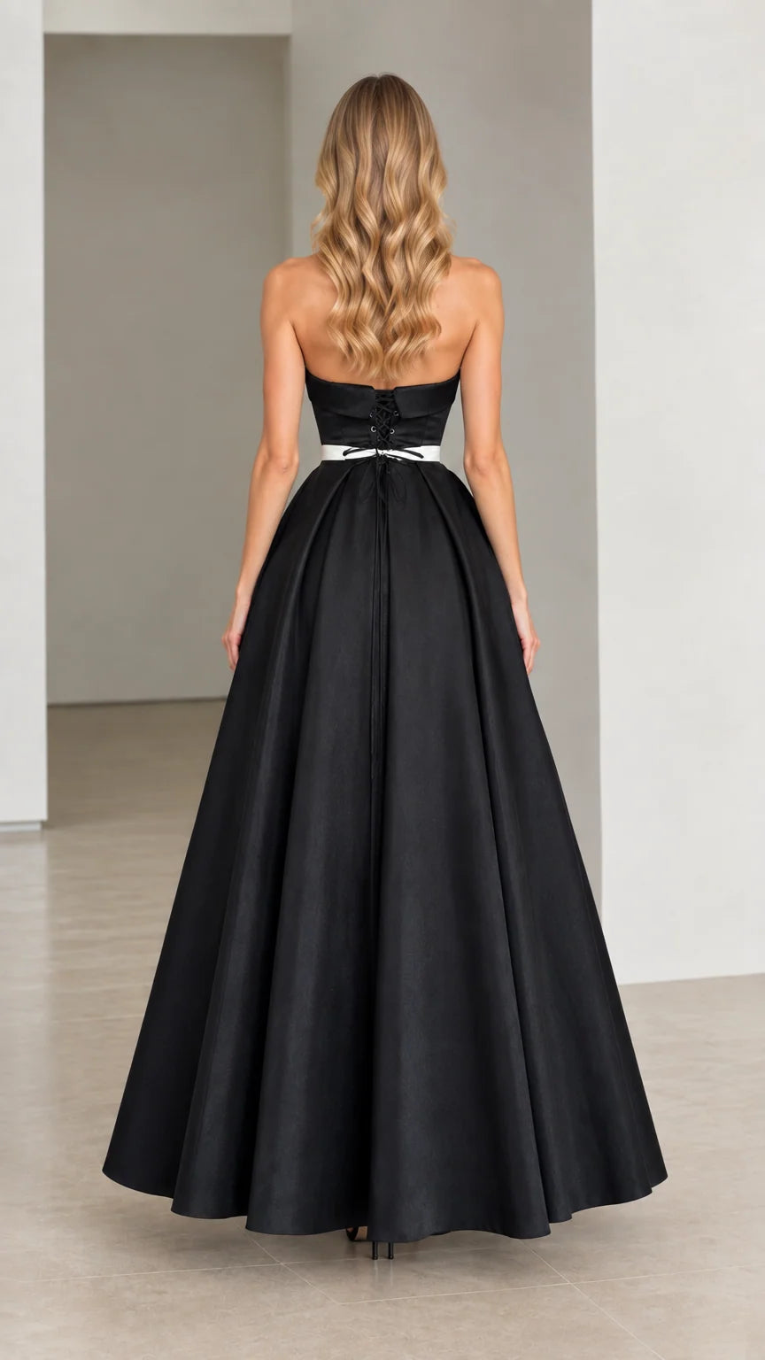 Rear view of strapless black gown showing lace-up corset back detail