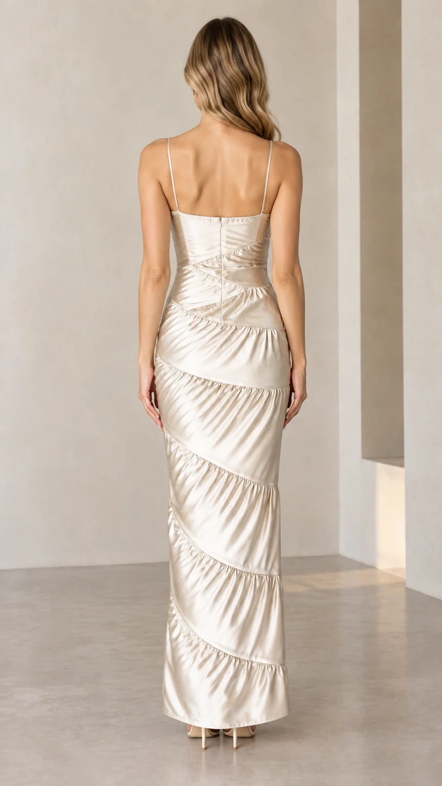 Back view of woman in Champagne spaghetti strap tiered satin gown
