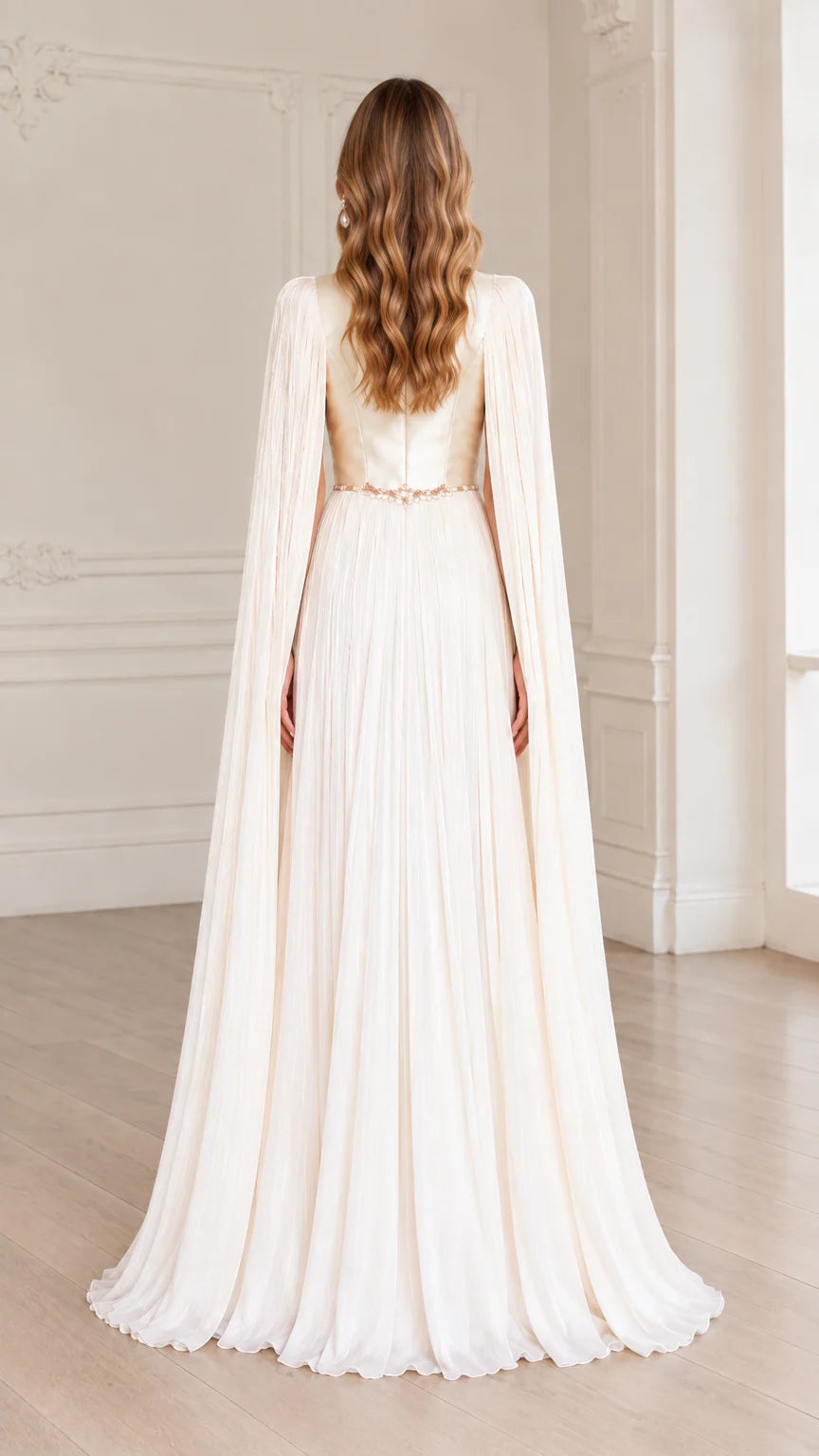 Back view of ivory floor-length gown with flowing pleated cape