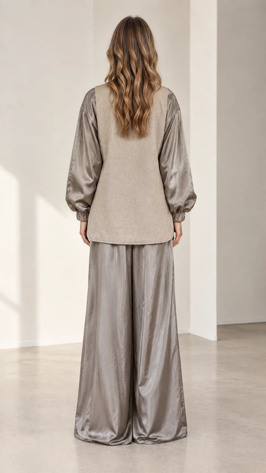 Back view of model wearing relaxed taupe contrast blazer and wide-leg trousers
