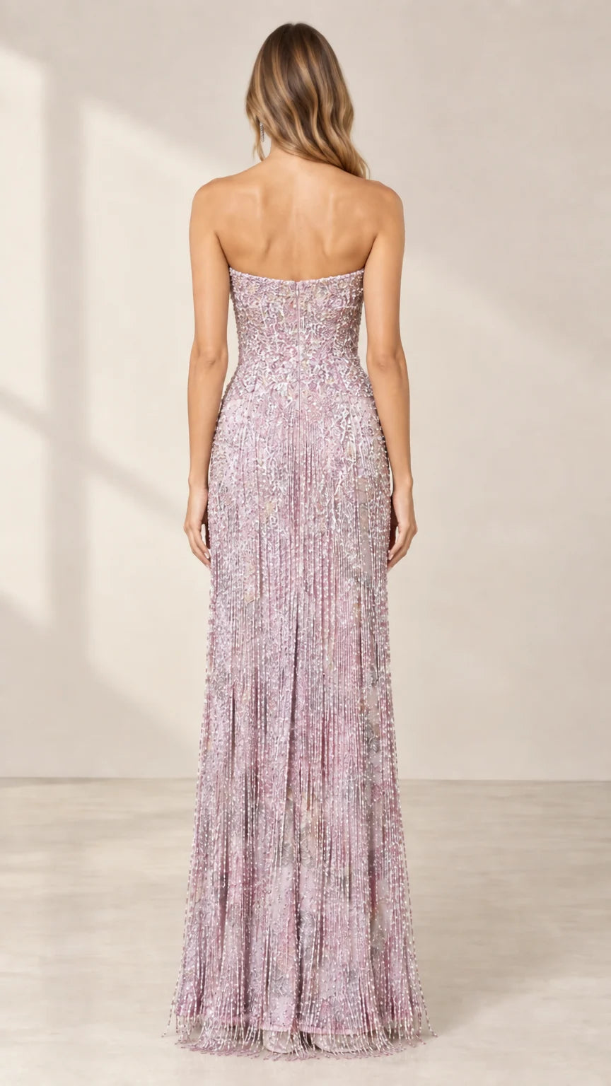 Back view of model wearing lilac strapless beaded formal gown