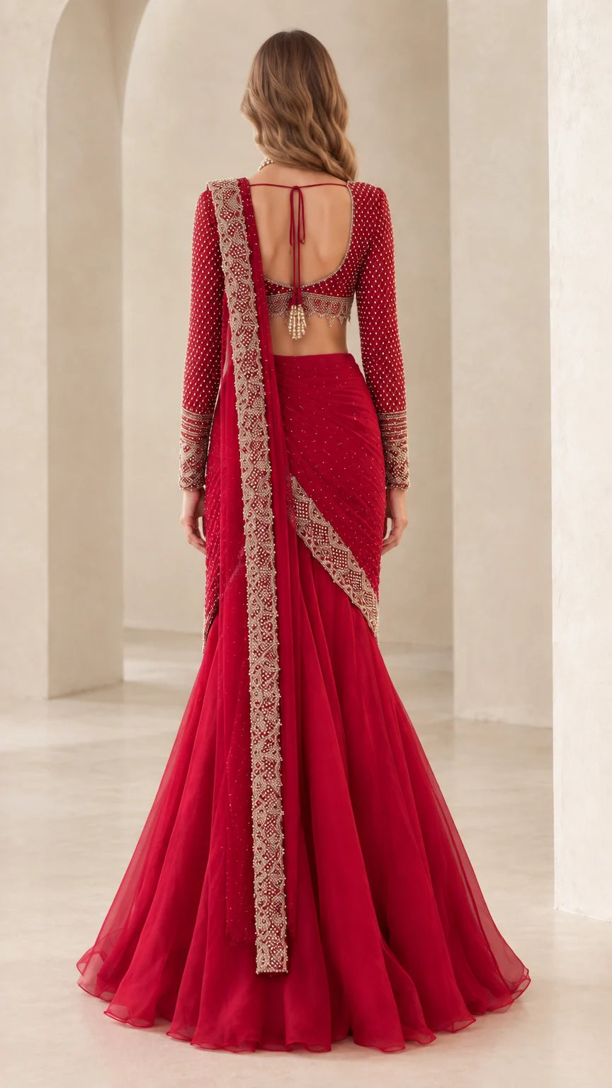 Back view of crimson red pre-draped lehenga saree showing pallu drape and open-back blouse detail