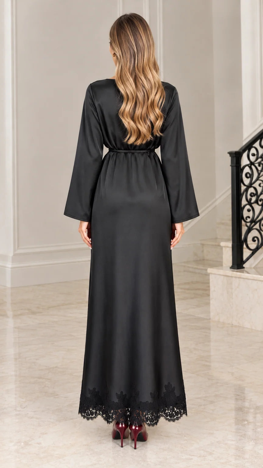 Back full-length view of elegant black satin evening dress