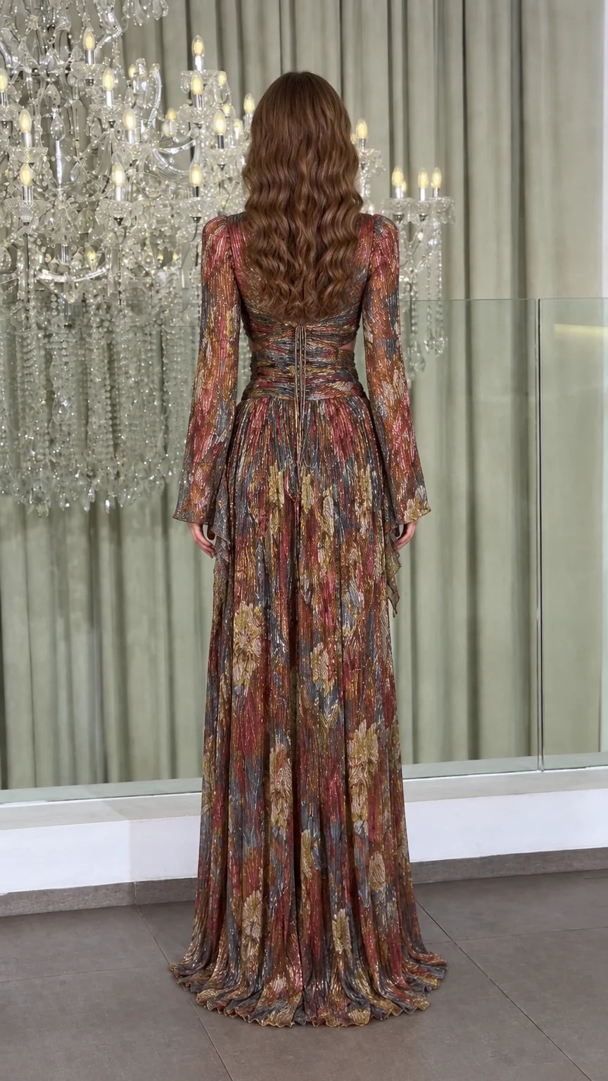 Back view of model wearing metallic plissé gown showcasing crisscross lace-up back