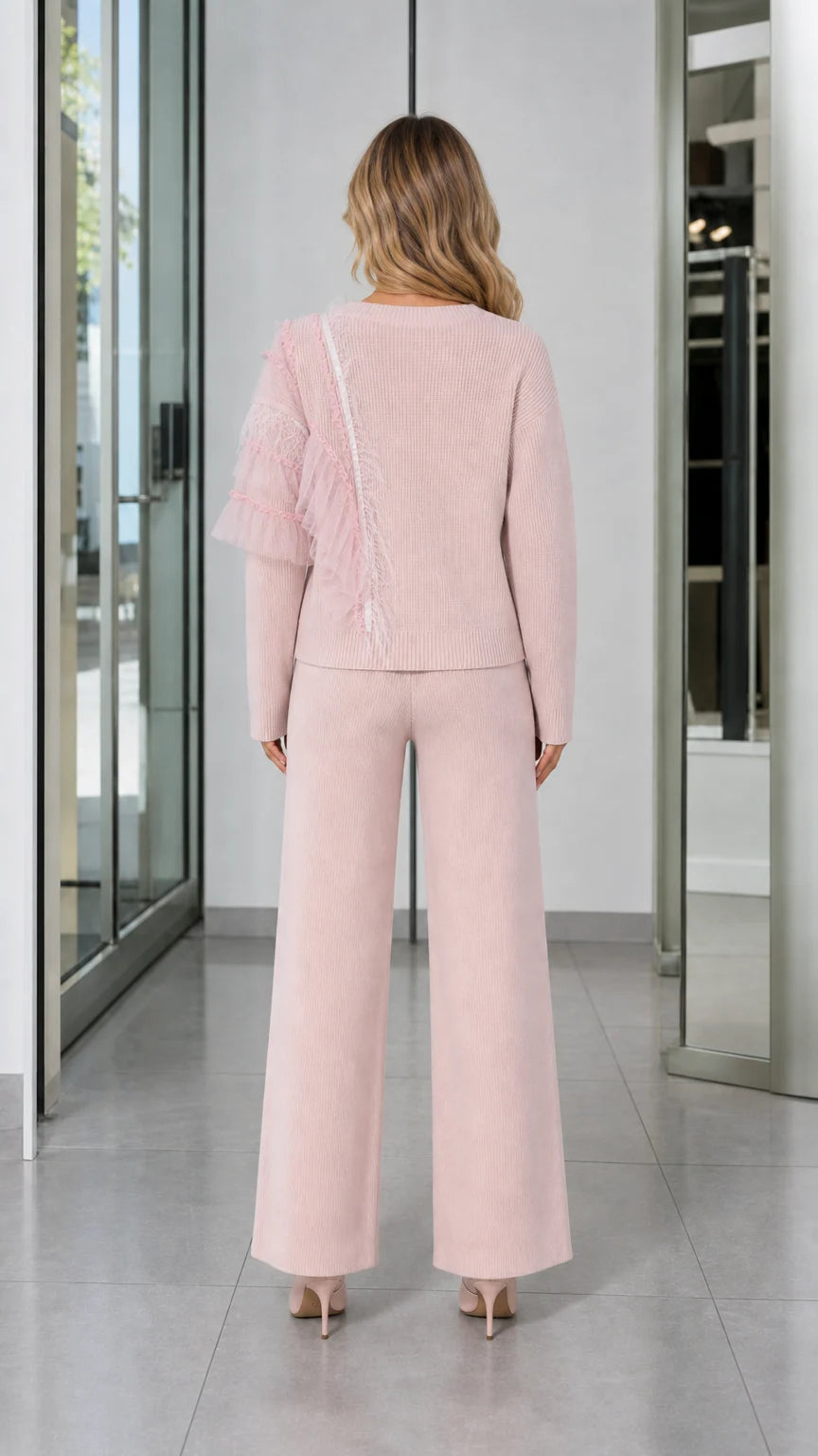 Back view of woman wearing Light Pink knit lounge sweater and drawstring wide-leg pants