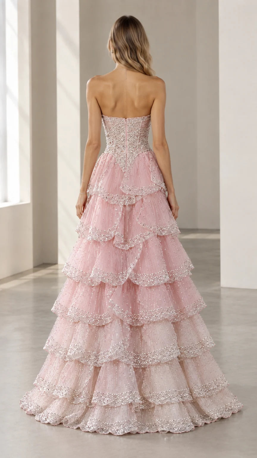 Back full-length view of the Blush Pink tiered tulle evening gown