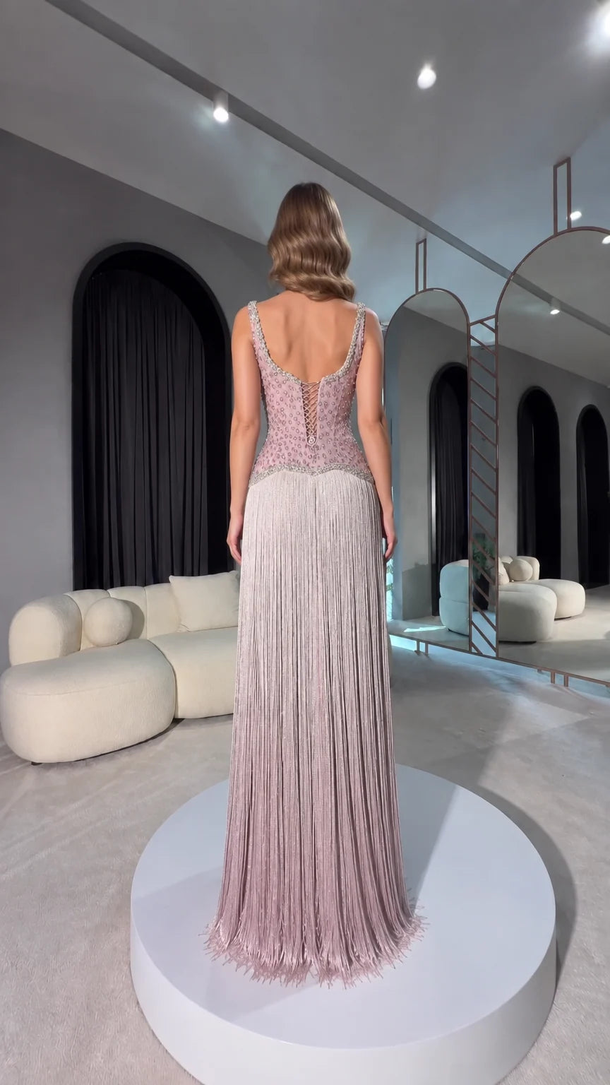 Back view of dusty mauve gown showing lace-up corset detail and fringe skirt
