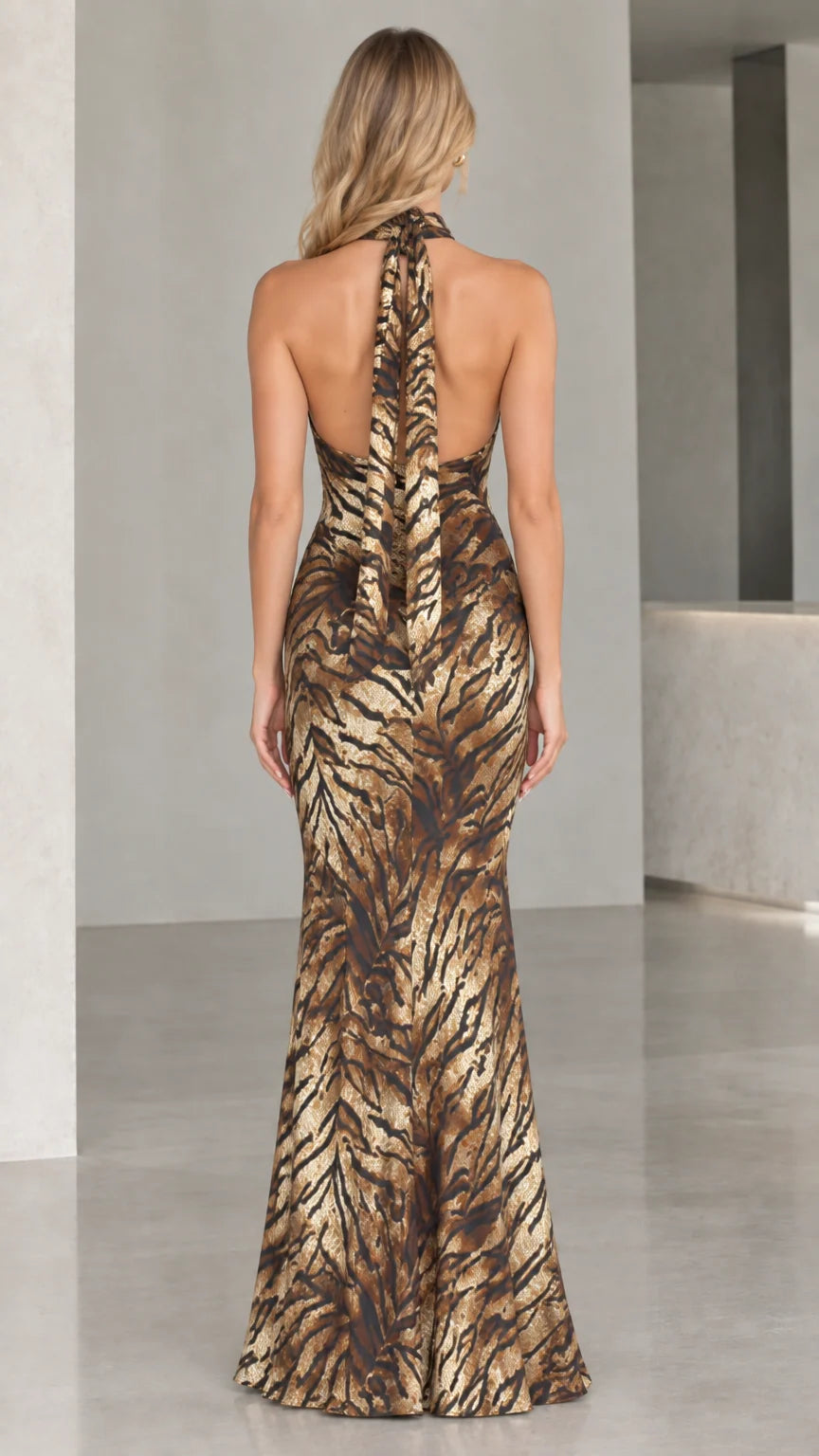 Back view of model showing open back and sash tie on Bronze Gold maxi gown