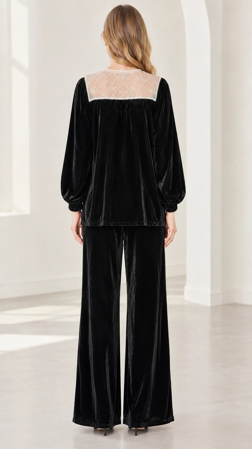 Back view of model showing black sheer lace back yoke on velvet long sleeve top