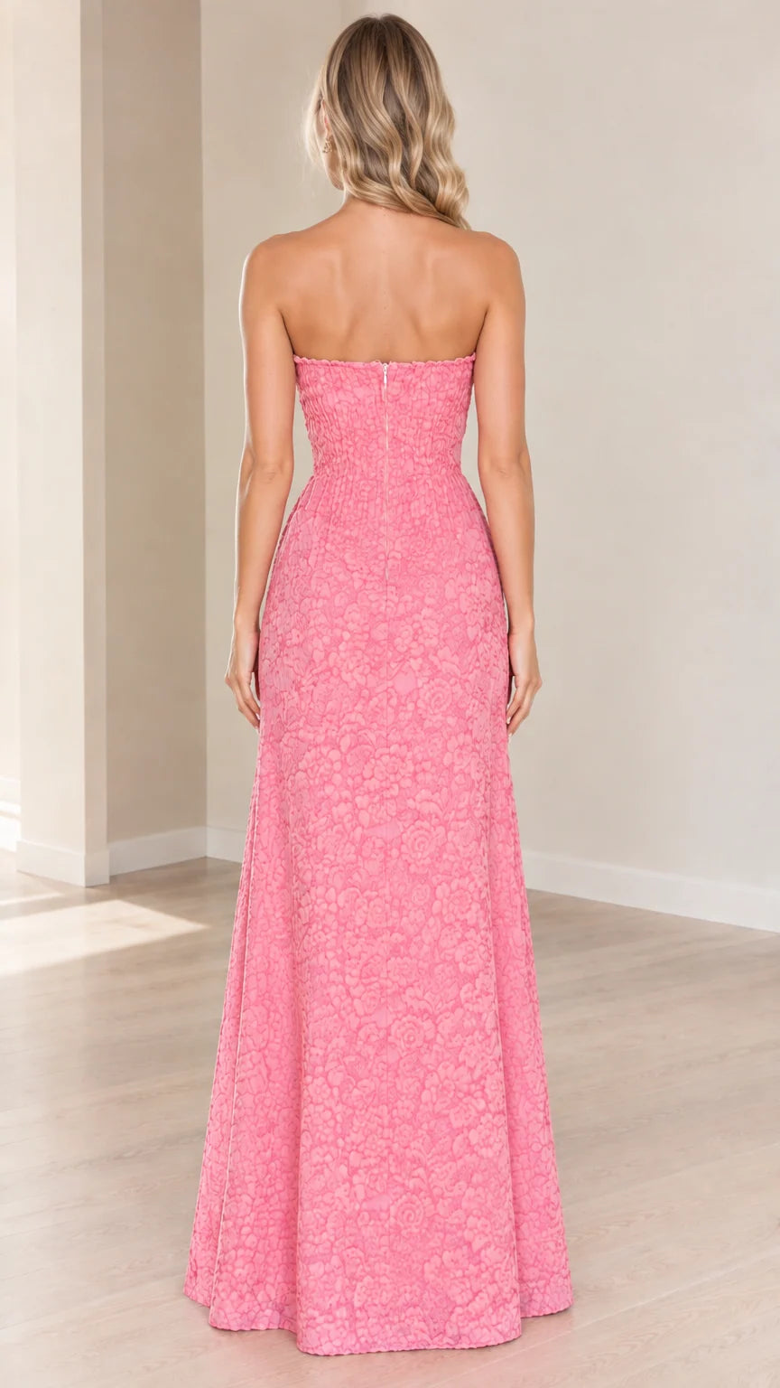 Back view of model wearing pink strapless floral textured maxi dress