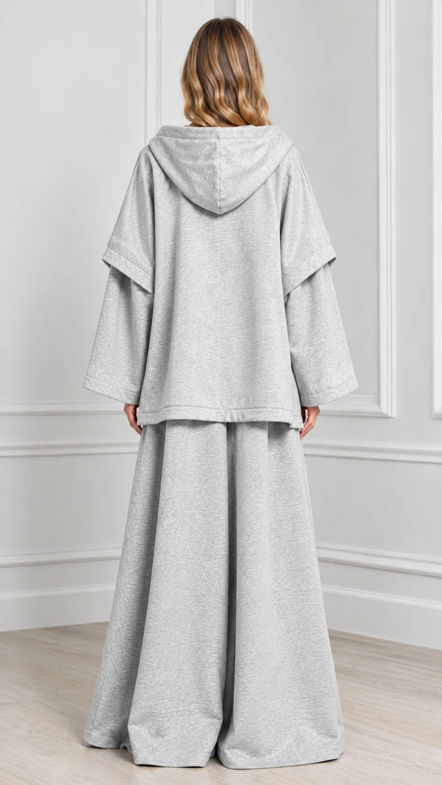 Back view of woman wearing Heather Grey hooded cape lounge set with hood detail
