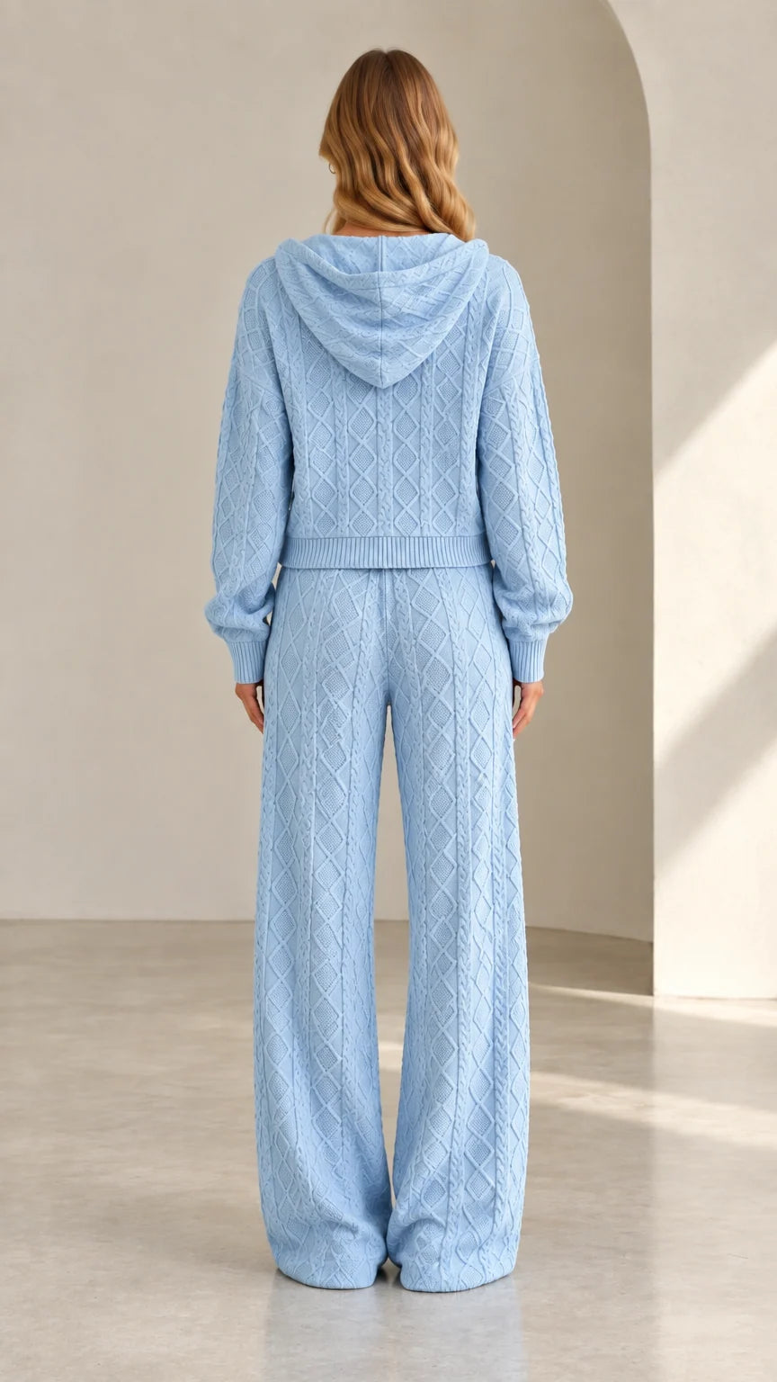 Back view of light blue cable knit hooded sweater and wide leg pants set