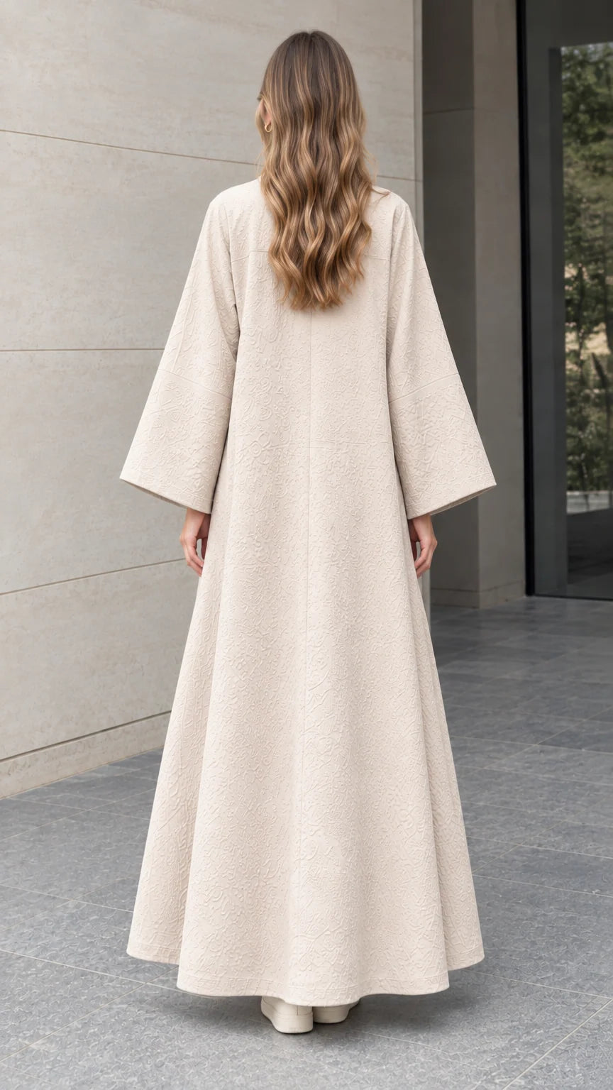 Back full-length view of woman wearing elegant beige floor-length jacquard duster