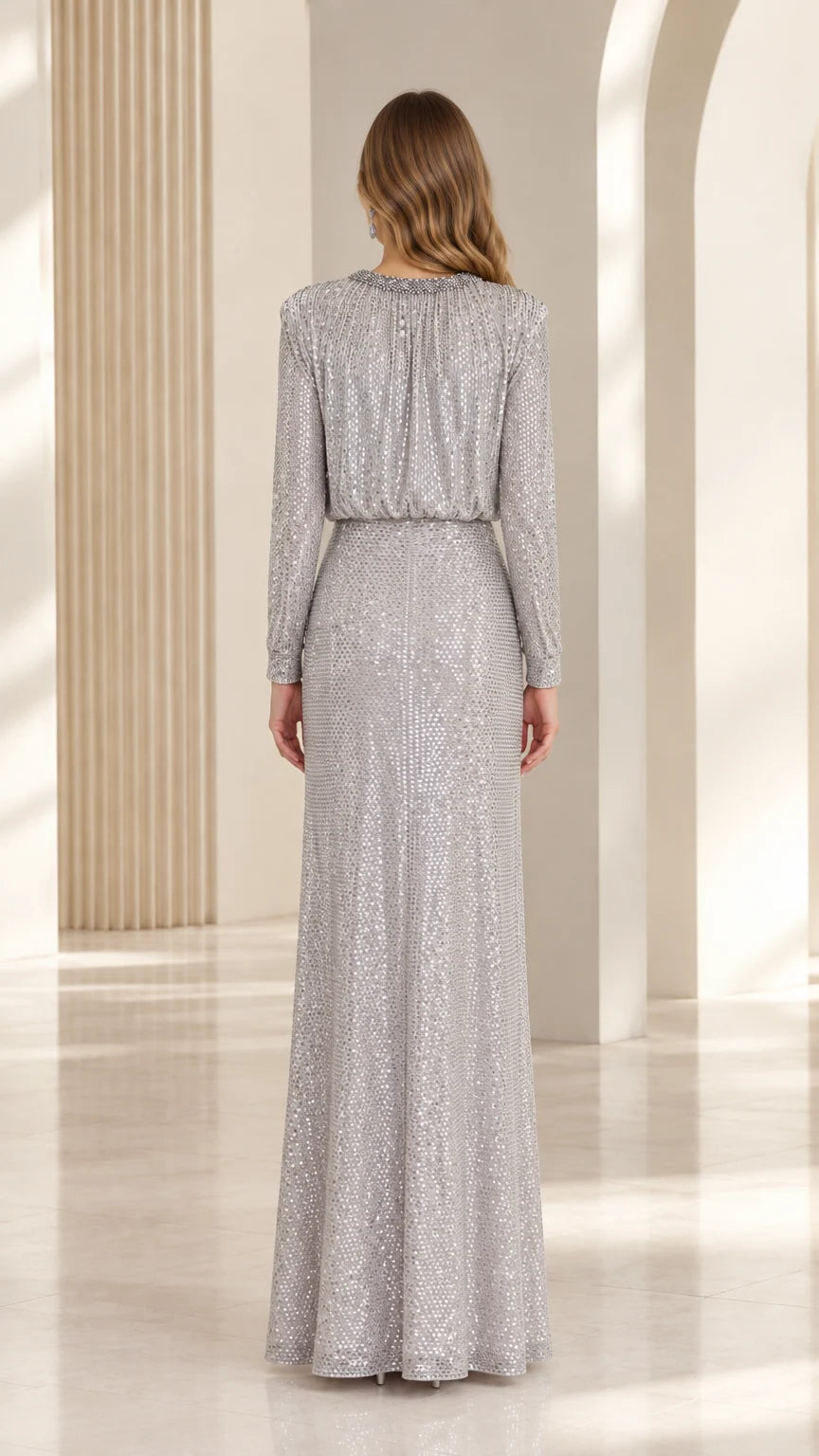 Back view of the silver sequin evening gown highlighting the blouson bodice and long skirt