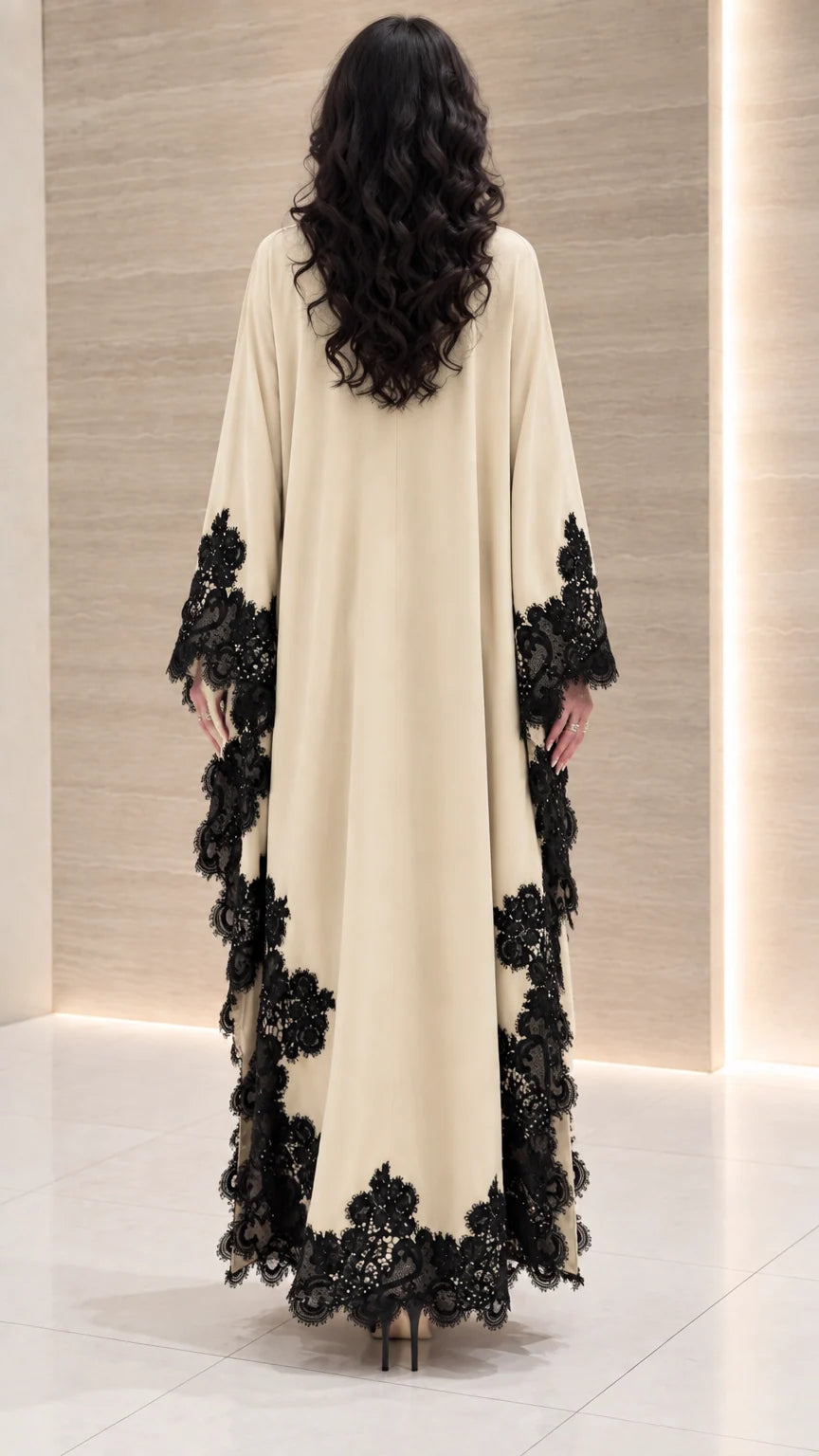 Back view of cream draped maxi dress showing flowing cape sleeves and lace details