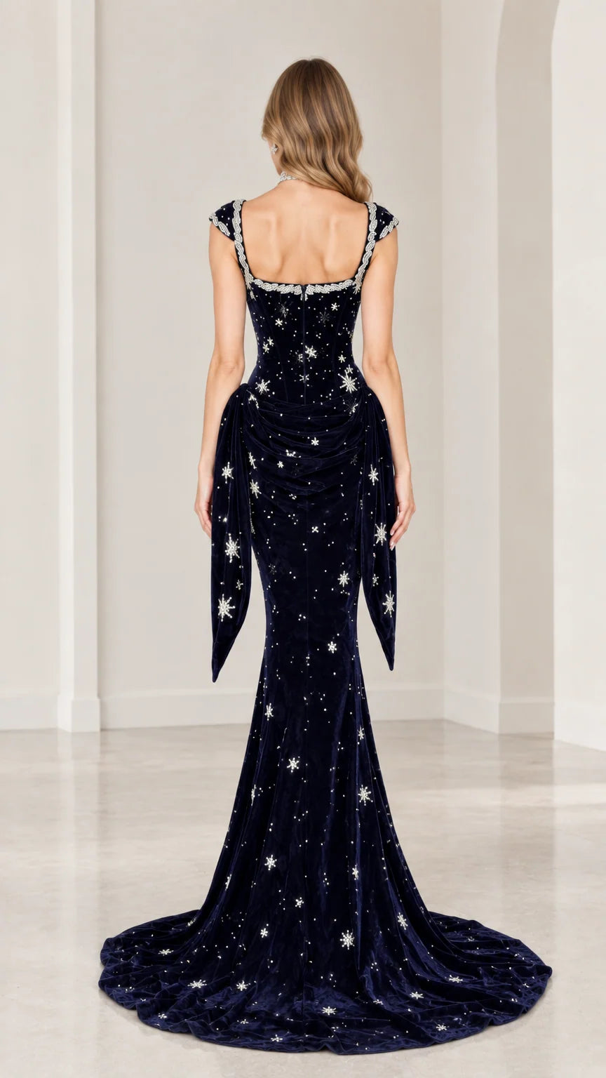 Back view of navy blue velvet formal gown showing tailored fit and long train