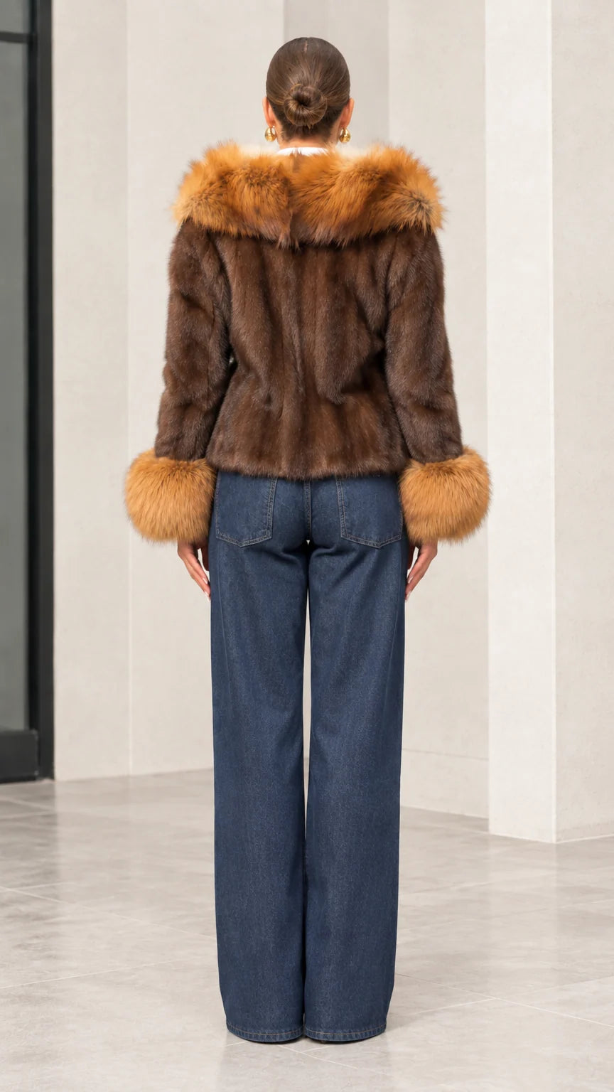 Back view of brown faux fur hooded short jacket showing plush hood detail and fitted silhouette