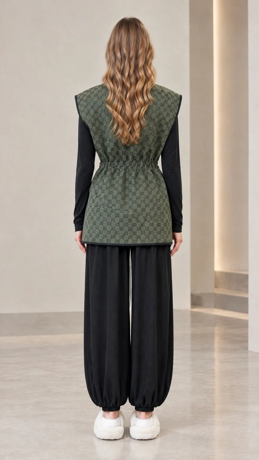 Back view of woman wearing olive green monogram drawstring waist vest