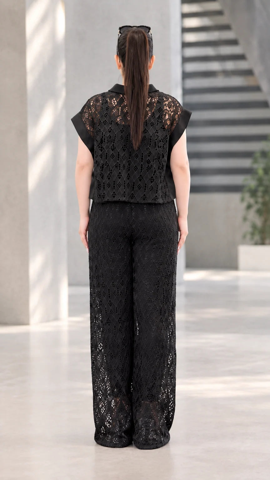Back full-length view of black lace collared blouse and flowing wide-leg pants