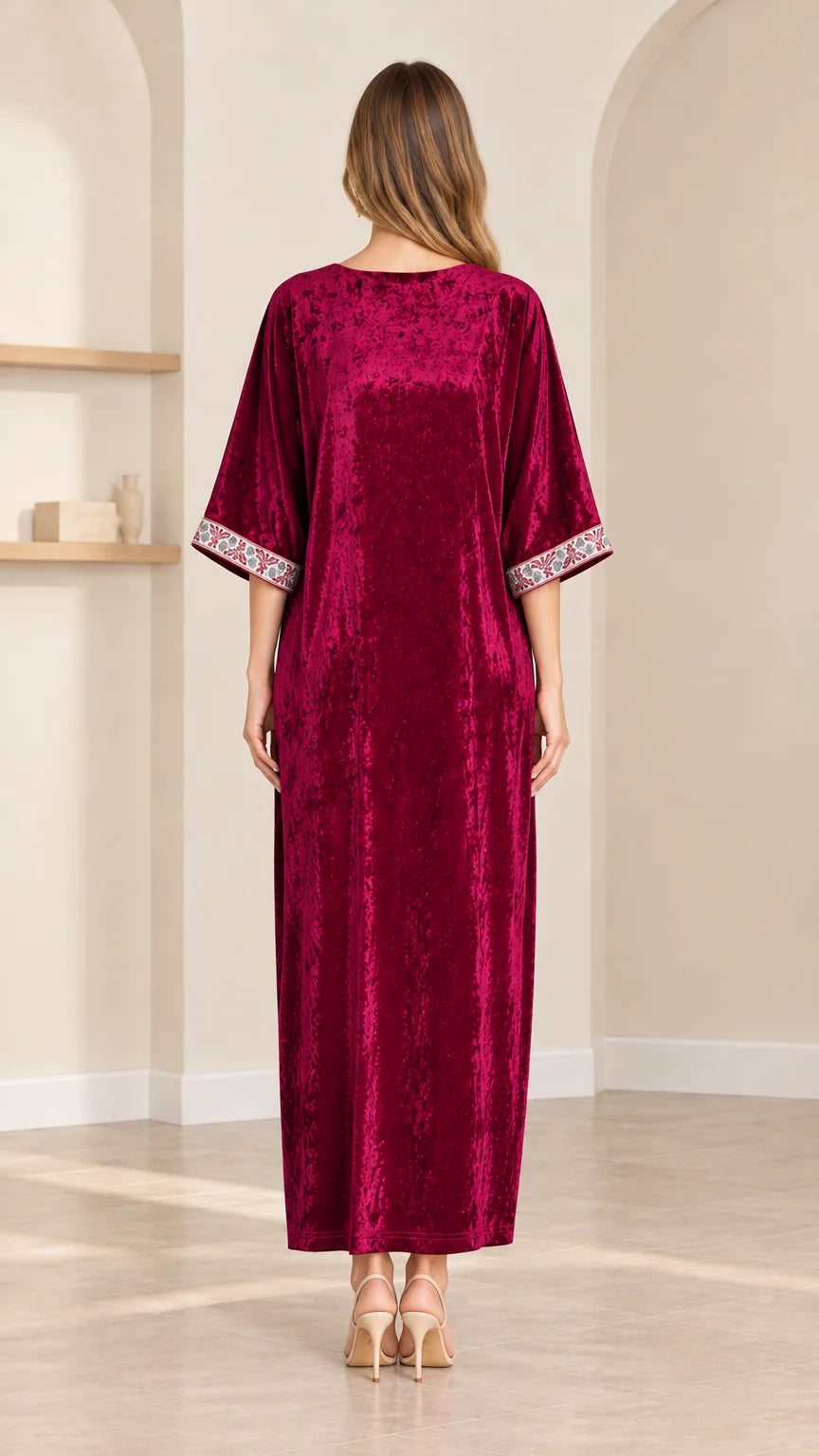 Back view of model wearing loose fit burgundy velvet kaftan dress