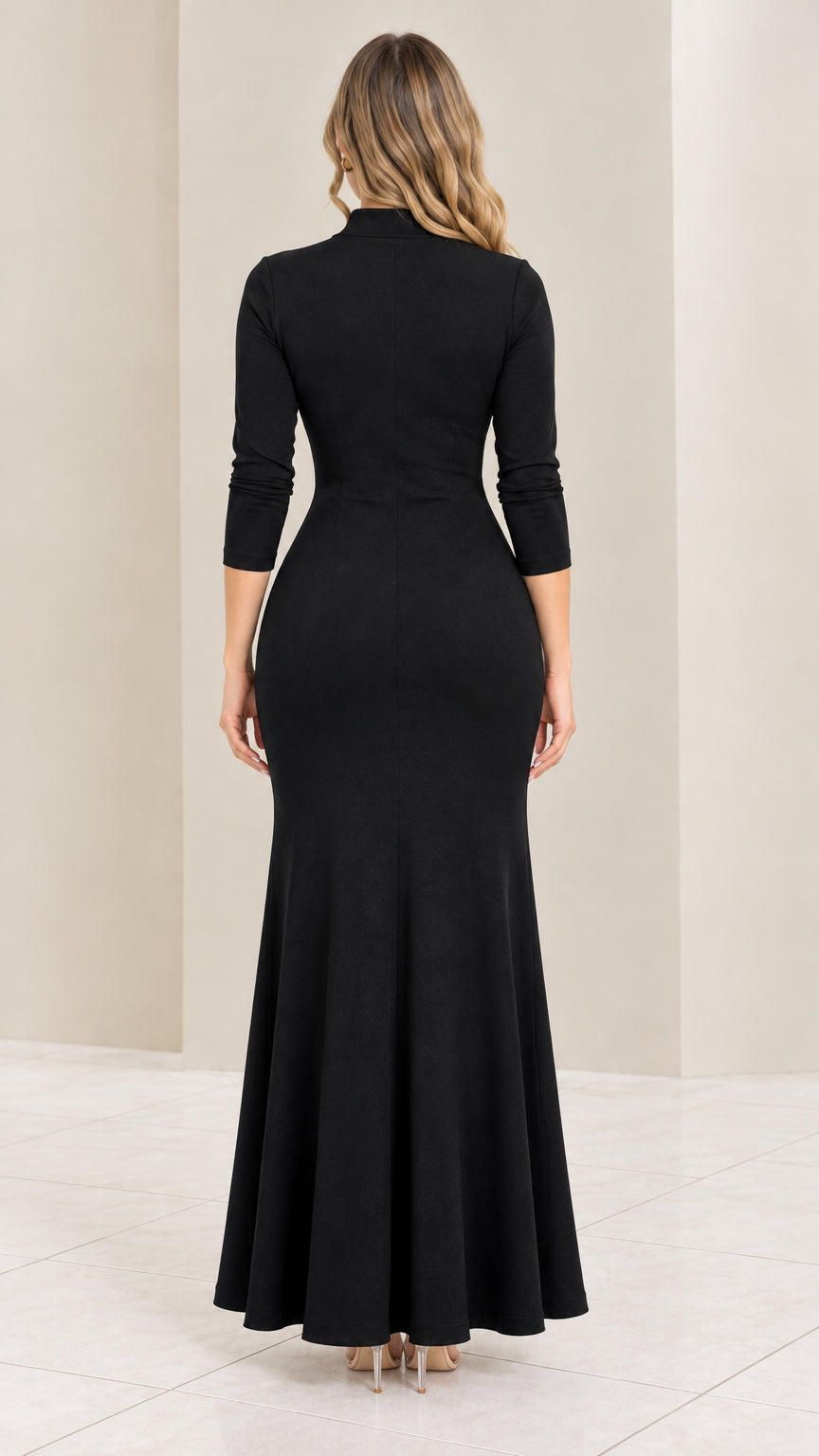 Back view of model wearing black fitted maxi dress with flared hem
