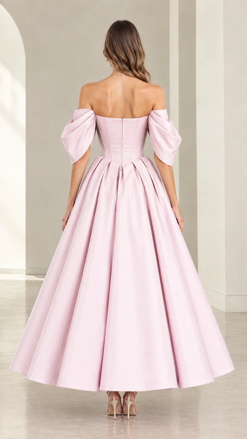 Back view of model showcasing Blush Pink corset back and pleated skirt