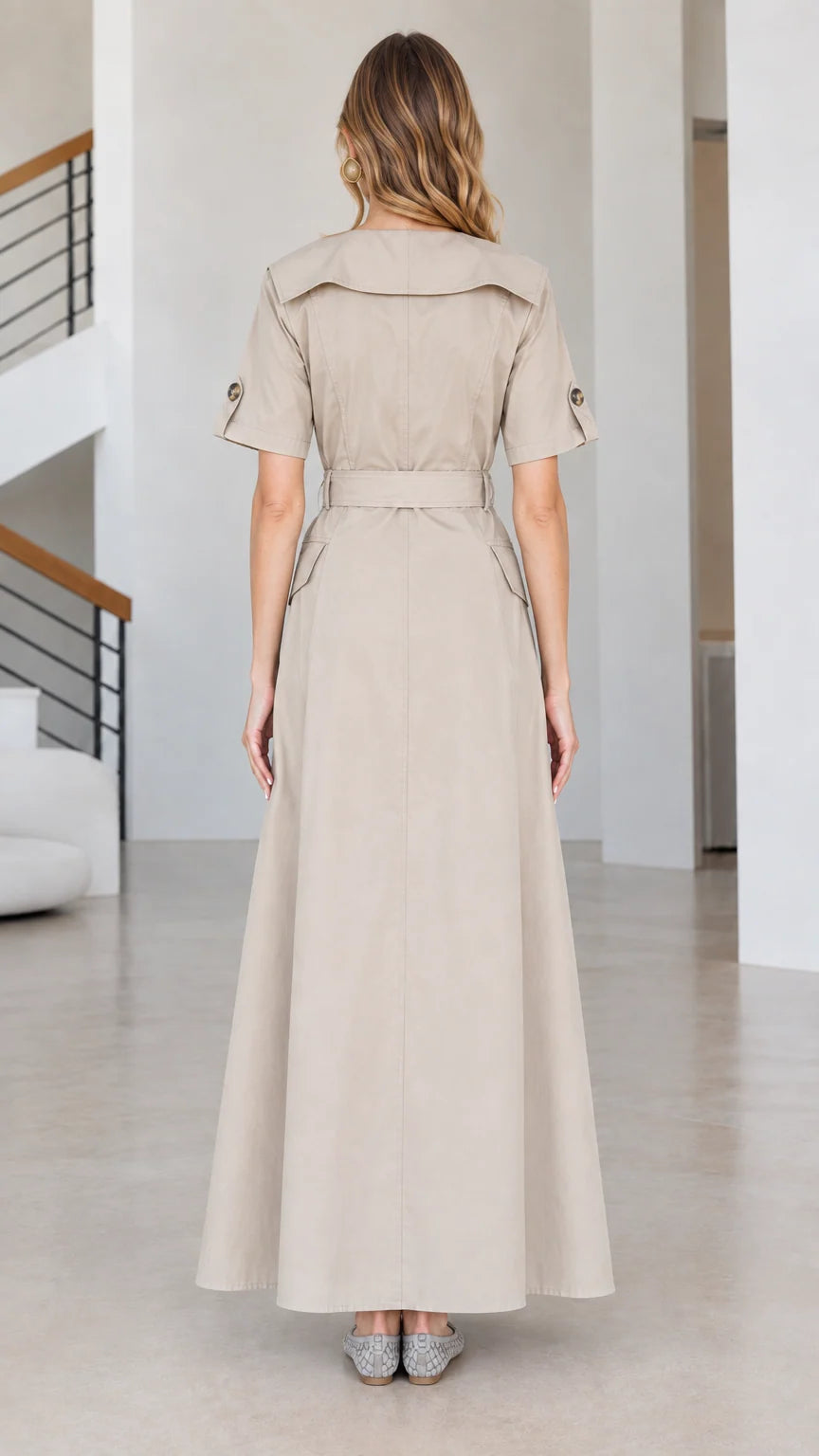 Back view of beige short-sleeve trench maxi dress with wide collar and belt