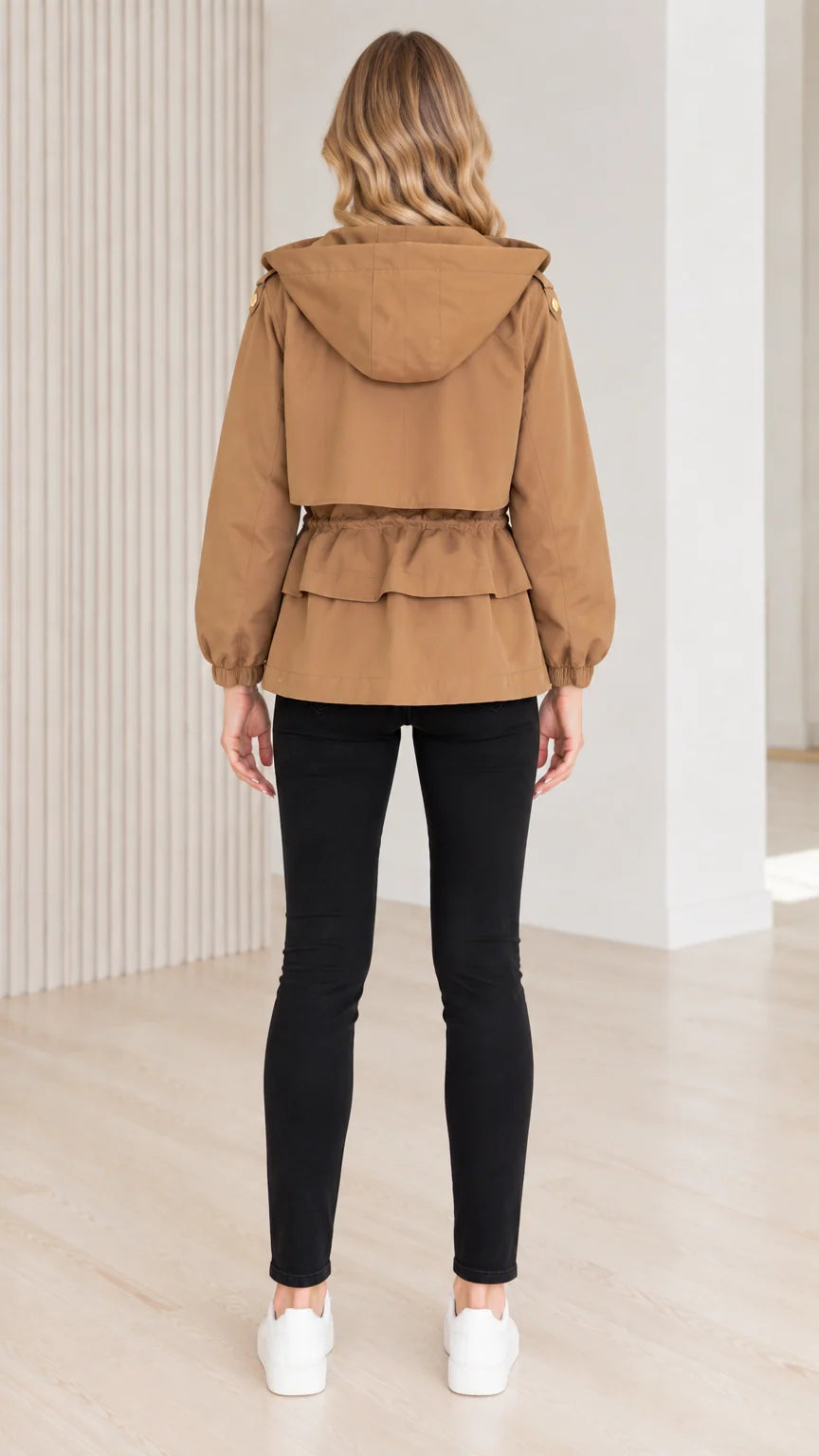 Back view of model wearing camel utility jacket showing tiered peplum ruffle hem