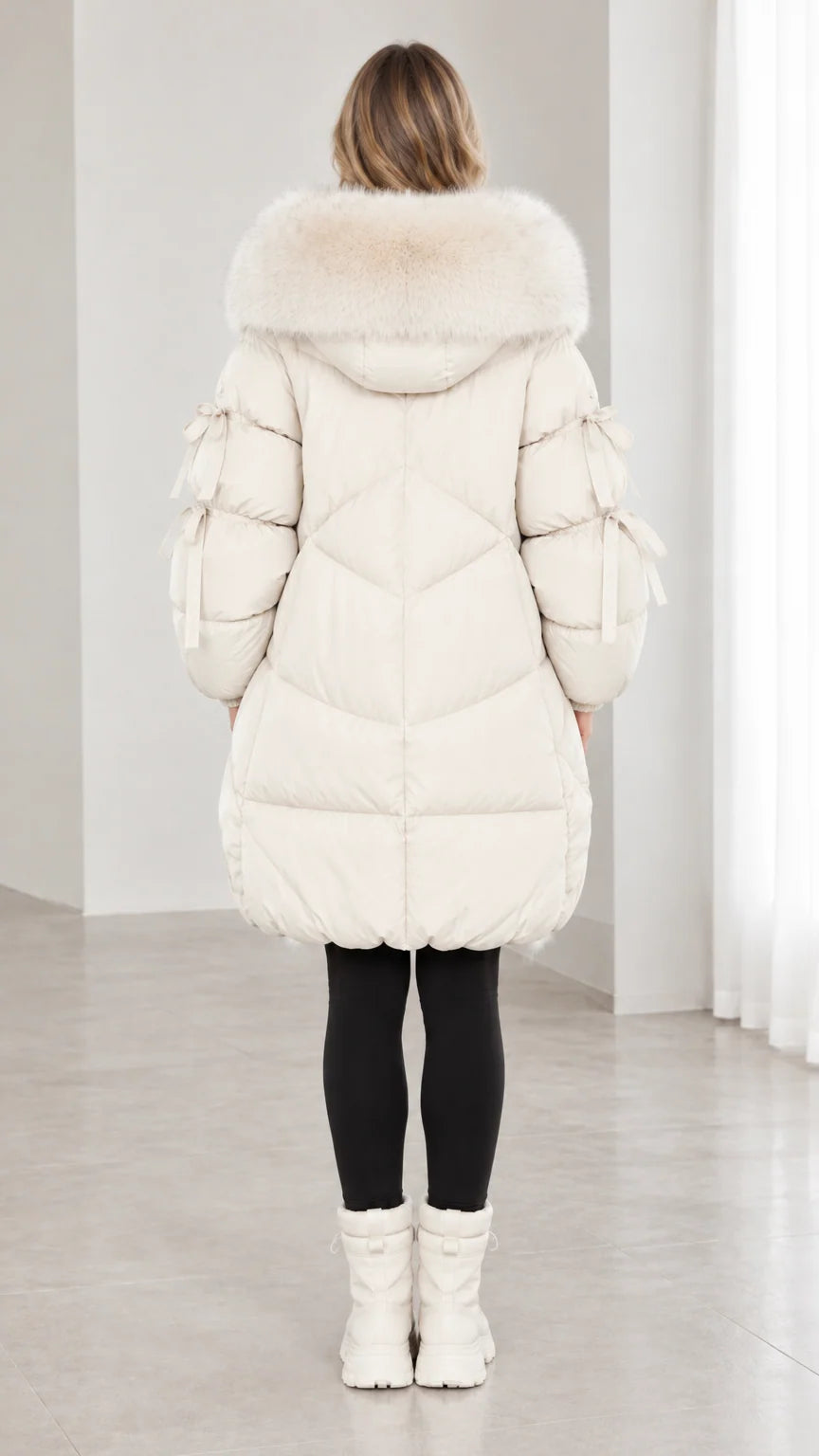 Back view of off white quilted winter puffer coat with large faux fur hood