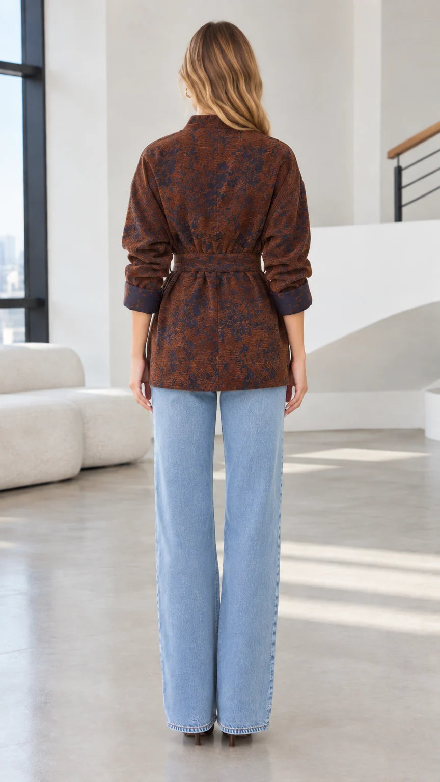 Back view of model wearing rust brown belted wrap jacket