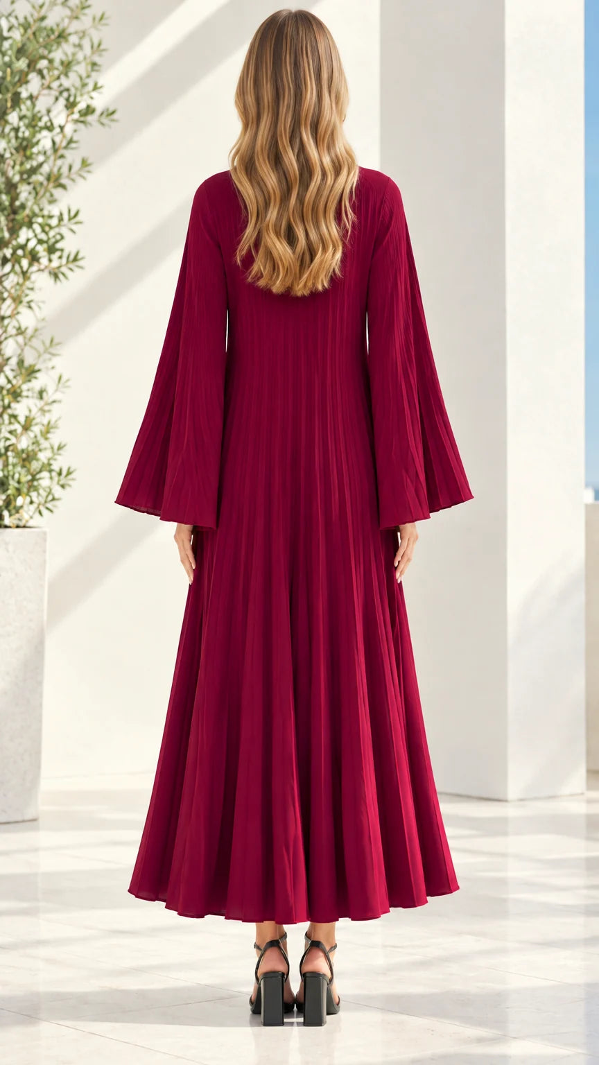 Back view of model wearing flowy burgundy pleated long sleeve maxi dress