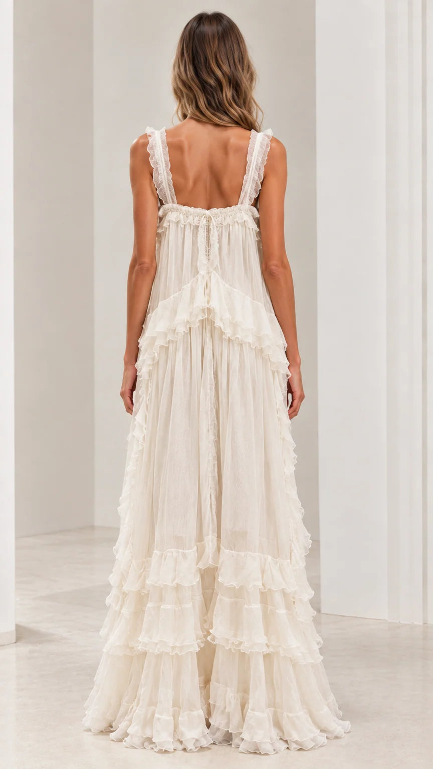 Back view of ivory ruffled strap maxi dress showcasing low back design