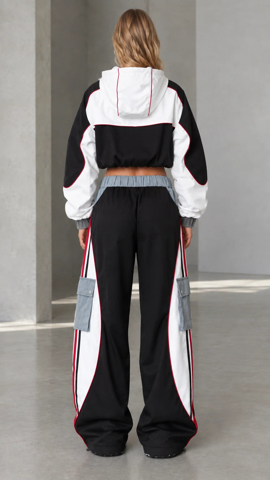 Back view of model wearing black cropped windbreaker jacket and oversized cargo pants
