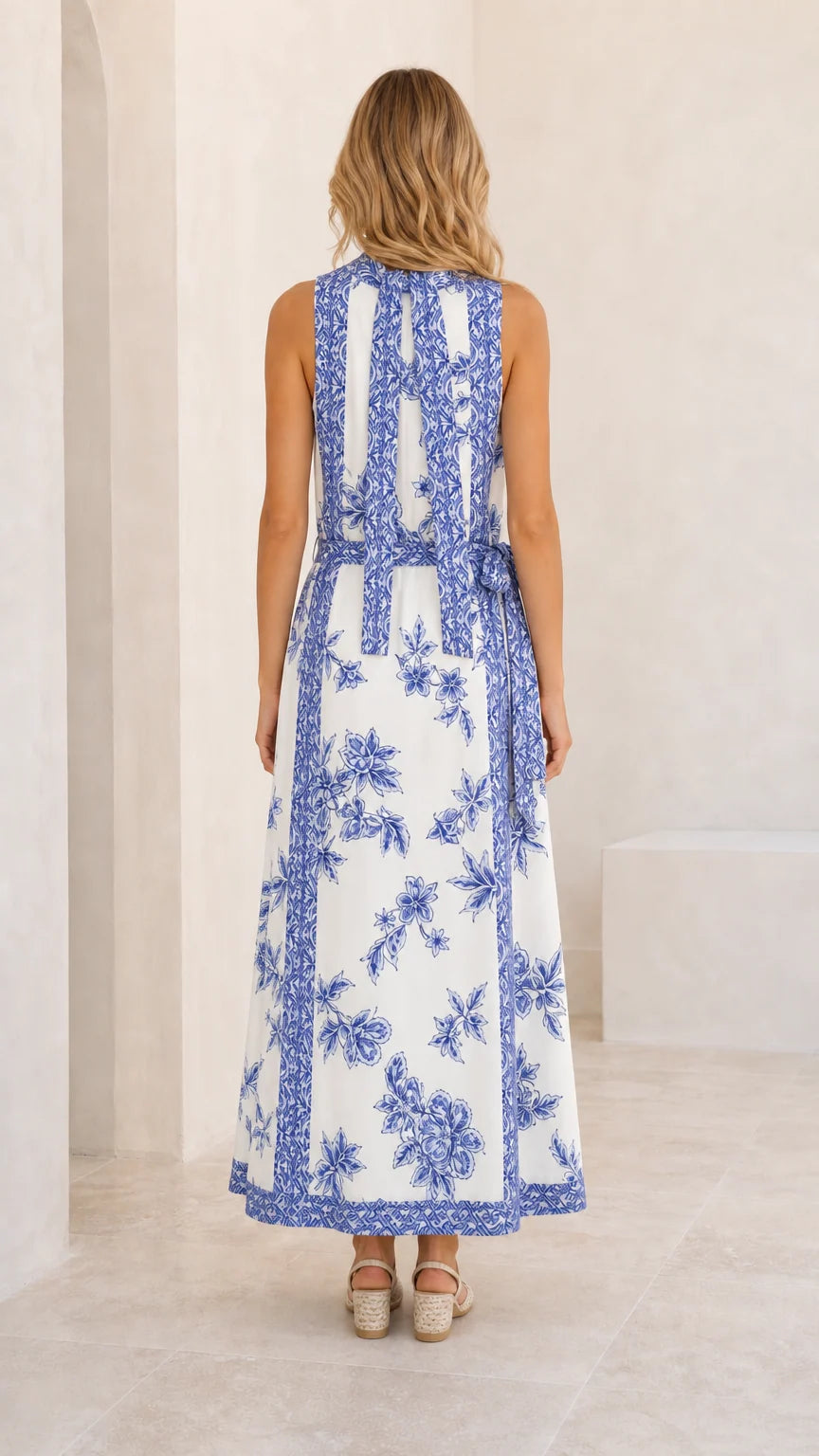 Back view of white floral maxi dress showing detailed neck tie